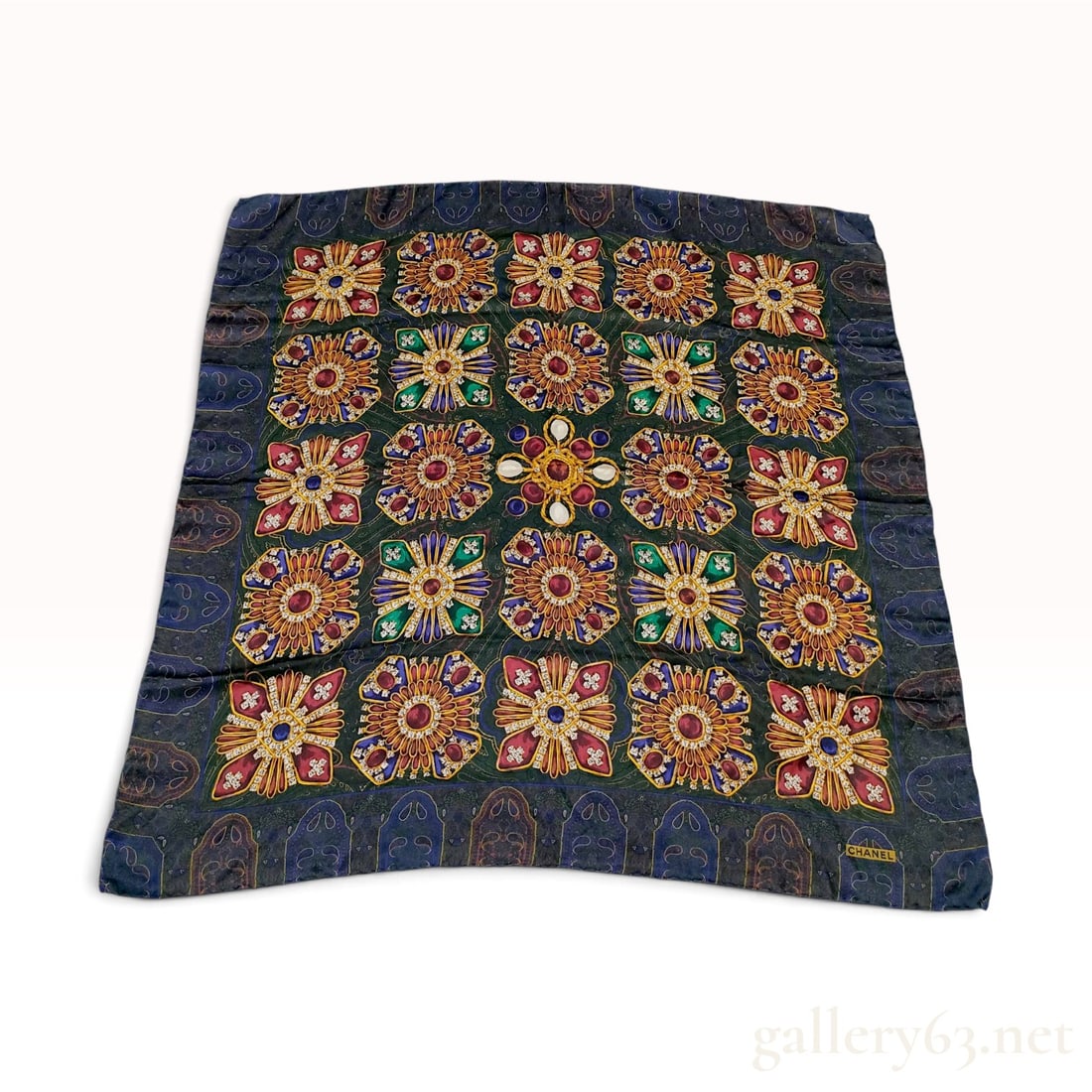 Chanel Gripoix Jewel Motif Silk Scarf: A square silk scarf by Chanel featuring an ornate Gripoix jewelry-themed print. The central field has a dark green ground with a subtle foliate pattern, overlaid with a grid of elaborate jewelry motif