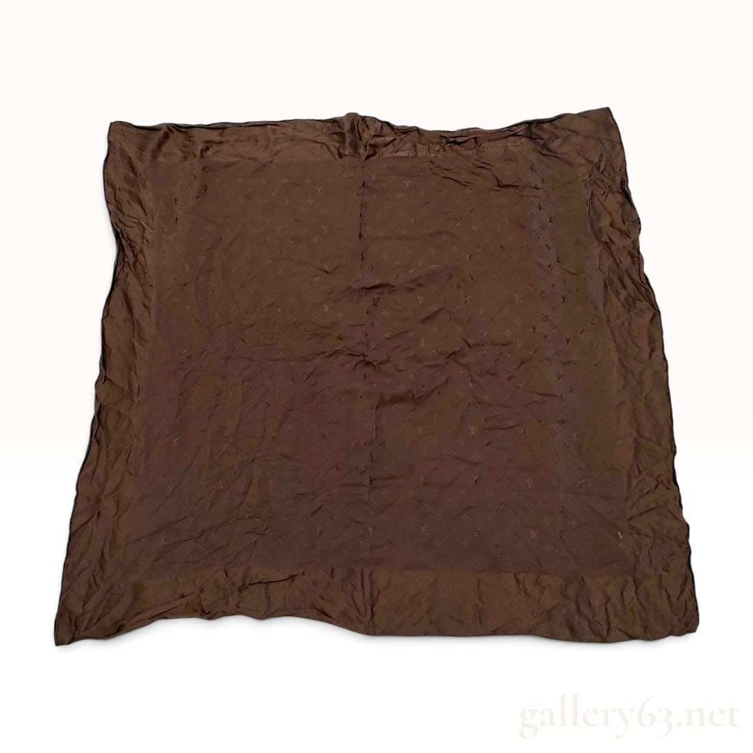 Louis Vuitton Monogram Dark Brown Silk Carre 90: This item is in pre-owned condition. A Louis Vuitton silk carre 90 featuring a tonal monogram jacquard weave in dark brown. The design includes the house initials, quatrefoils, and flowers throughout 