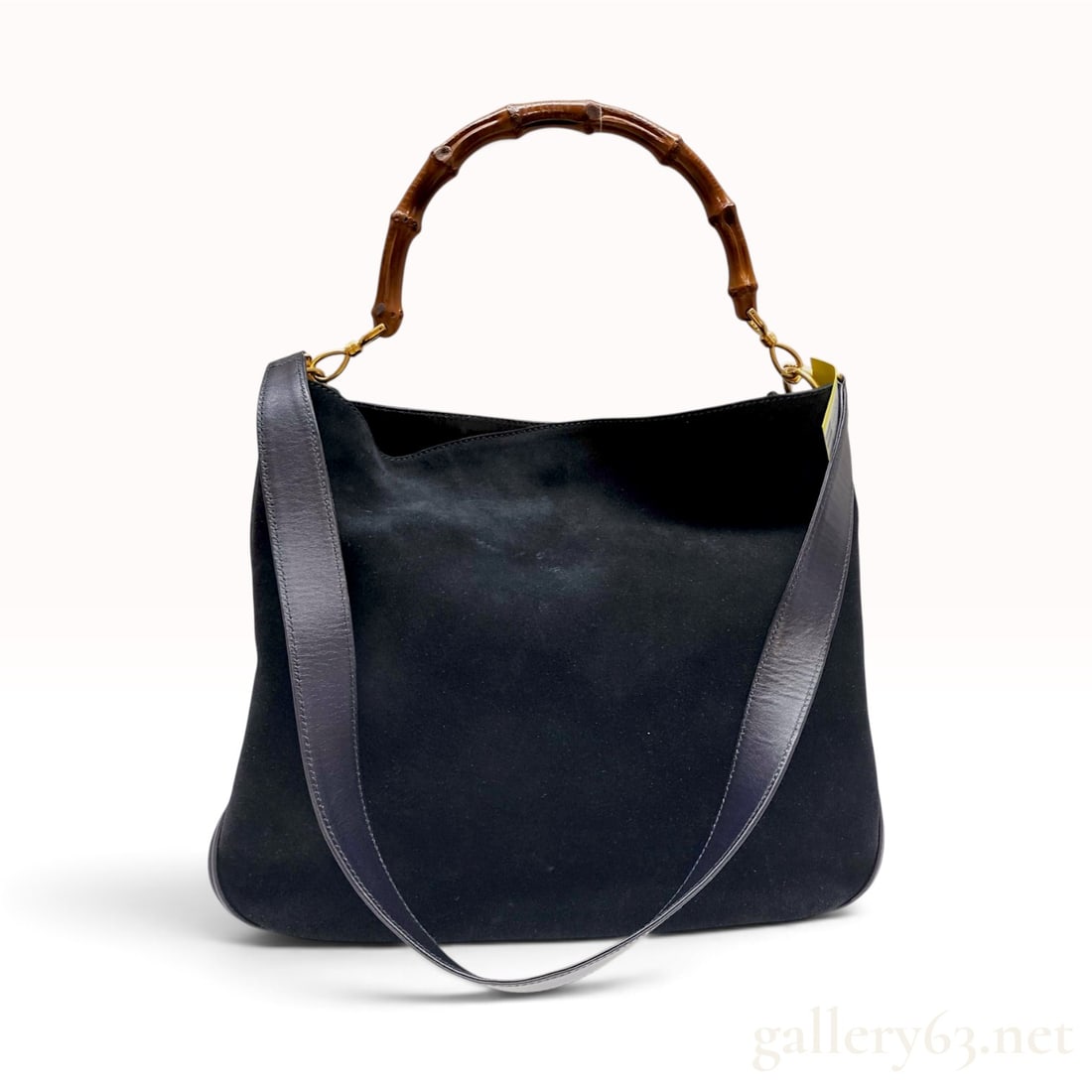 Gucci Vintage Black Suede and Leather Bamboo Handle Hobo Bag: A Gucci hobo-style handbag featuring a black suede body with a smooth black leather base, side panels, and trim. The design is characterized by its signature burnished bamboo top handle attached to go