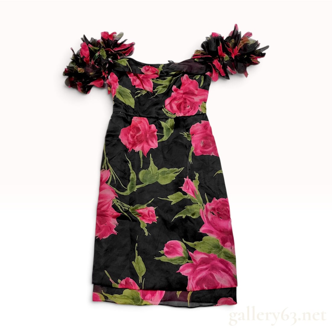 D&G Dolce and Gabbana Floral Print Silk Ruffle Mini Dress: A vintage D&G Dolce and Gabbana off-the-shoulder mini dress featuring a large-scale rose floral print in vibrant pink and green tones on a black ground. The garment is constructed with a 100 percent s