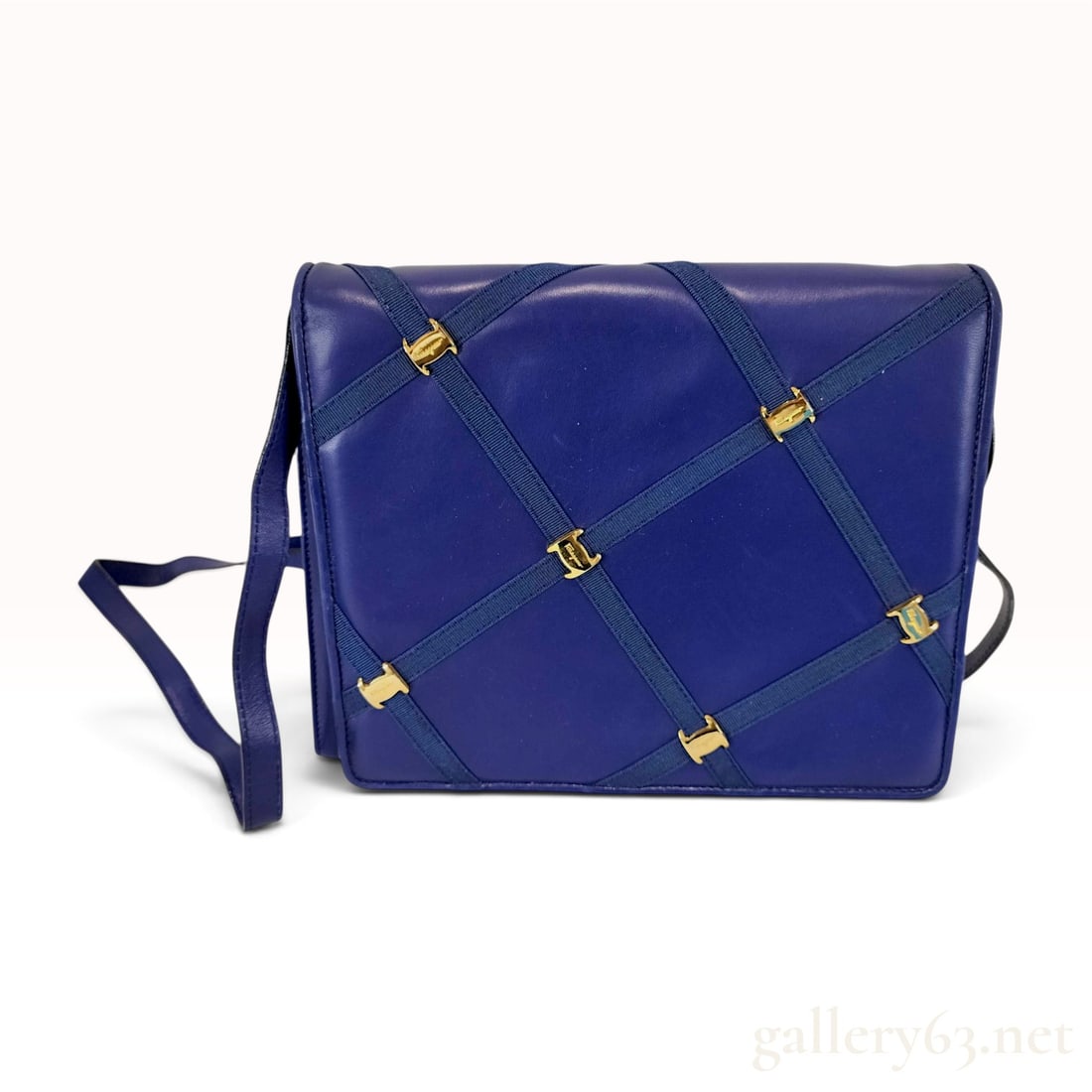 Salvatore Ferragamo Vintage Navy Blue Leather Grosgrain Lattice Shoulder Bag: A vintage Salvatore Ferragamo shoulder bag crafted from navy blue leather featuring a diagonal lattice overlay of matching grosgrain ribbon. The lattice pattern is accented at each intersection with s