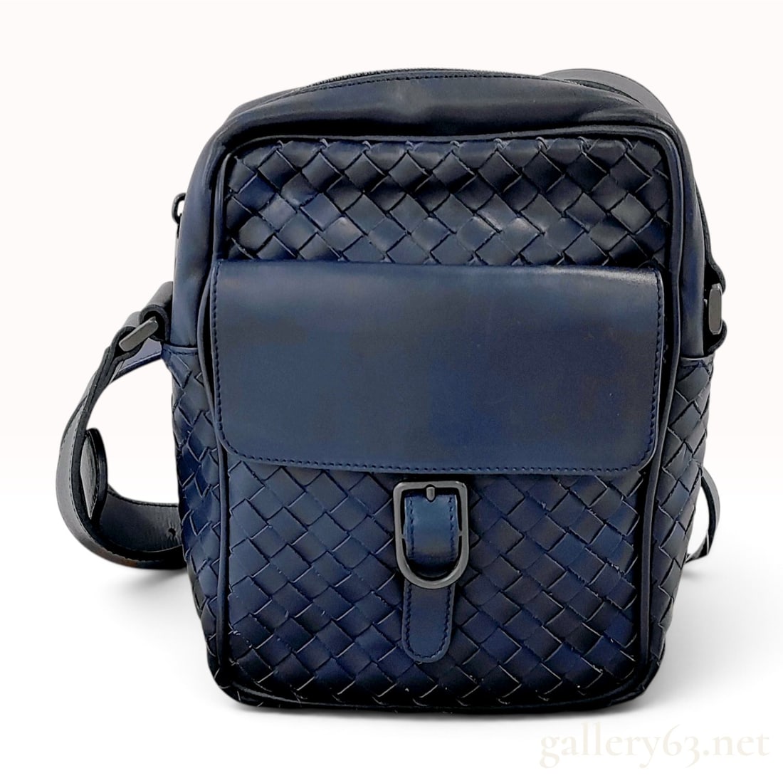 Bottega Veneta Navy Blue Intrecciato Leather Messenger Bag: A Bottega Veneta crossbody messenger bag constructed from navy blue hand-woven nappa leather using the signature Intrecciato weave. The rectangular bag features a front flap pocket secured by a leathe