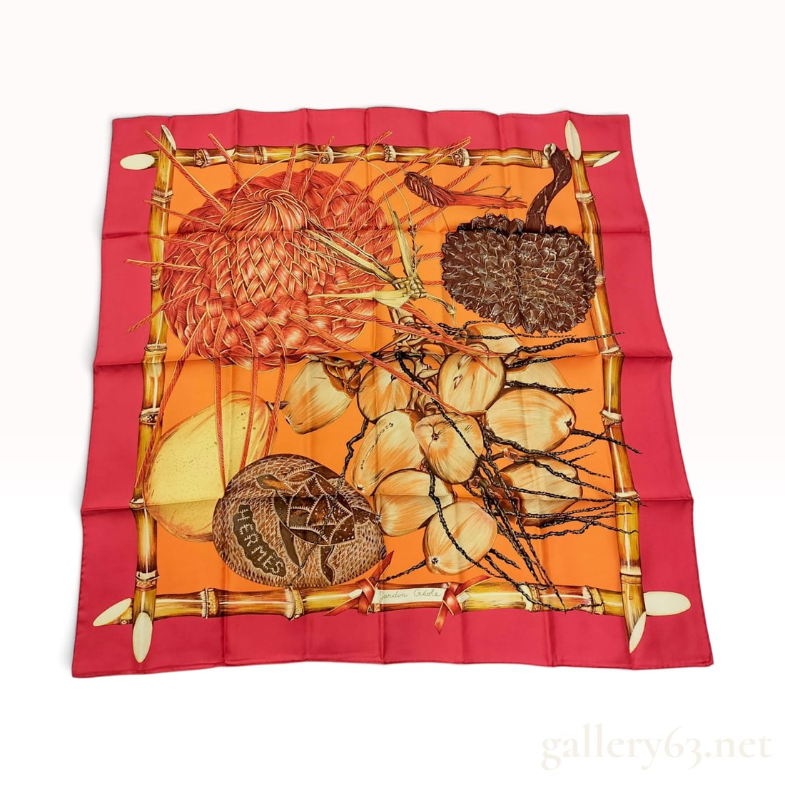 Hermes Jardin Creole Silk Twill Scarf: A Hermes silk twill scarf featuring the Jardin Creole pattern designed by Valerie Dawlat-Dumoulin. The central composition presents a lush tropical still life including a bunch of coconuts, a large so