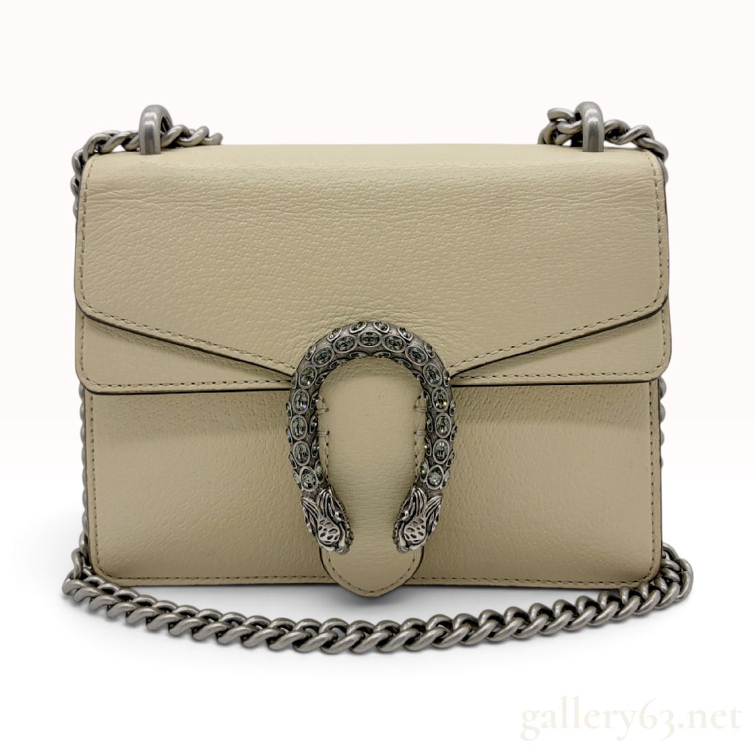 Gucci Dionysus Super Mini Grained Leather Shoulder Bag: Gucci Dionysus Super Mini shoulder bag crafted from cream-colored grained calfskin leather. The exterior features a flap front secured by a snap-button closure positioned beneath a signature antiqued 