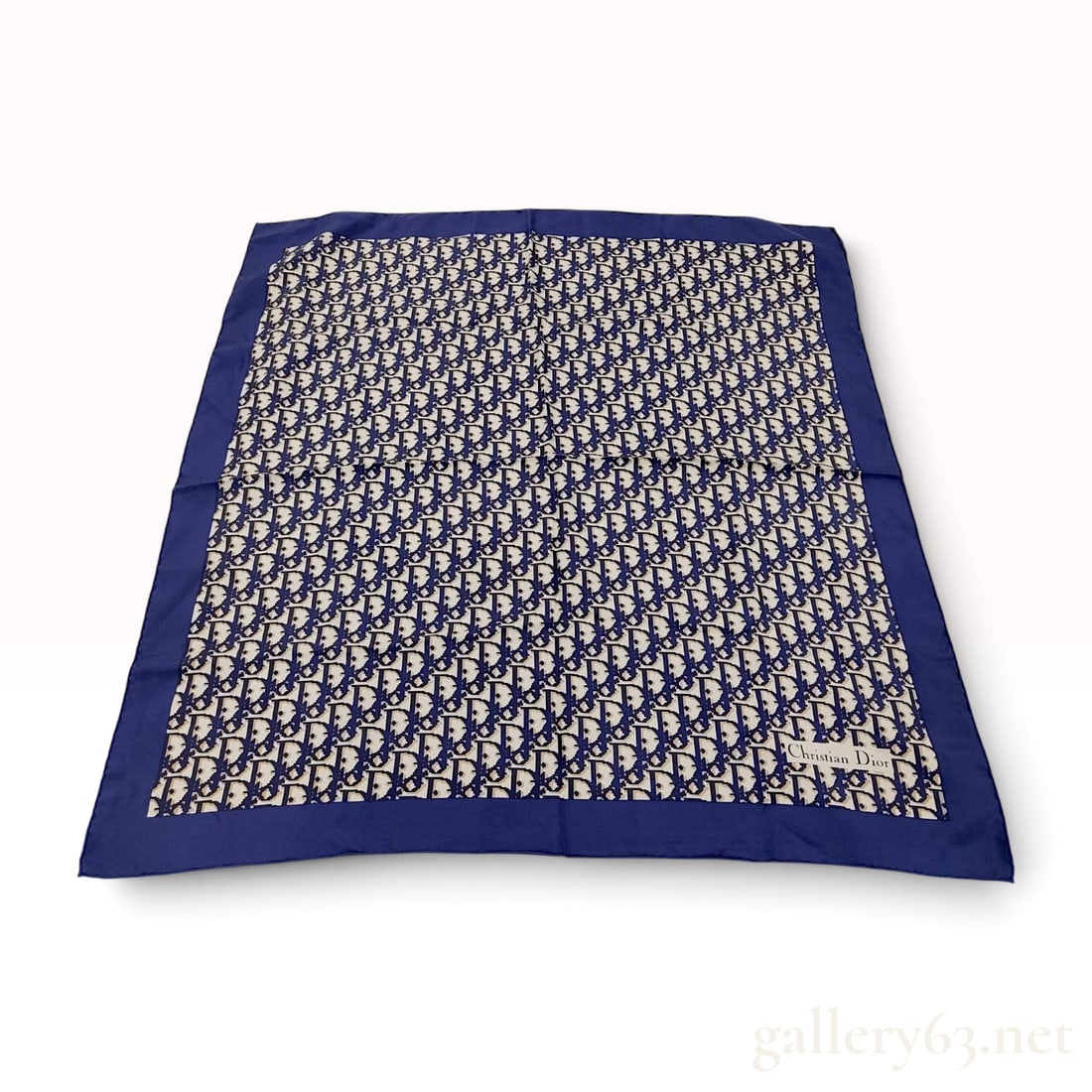 Christian Dior Vintage Navy Blue Oblique Monogram Silk Scarf: A vintage Christian Dior silk square scarf featuring the brand's iconic Oblique monogram pattern in navy blue on a cream ground. The design is framed by a solid navy blue border and finished with hand