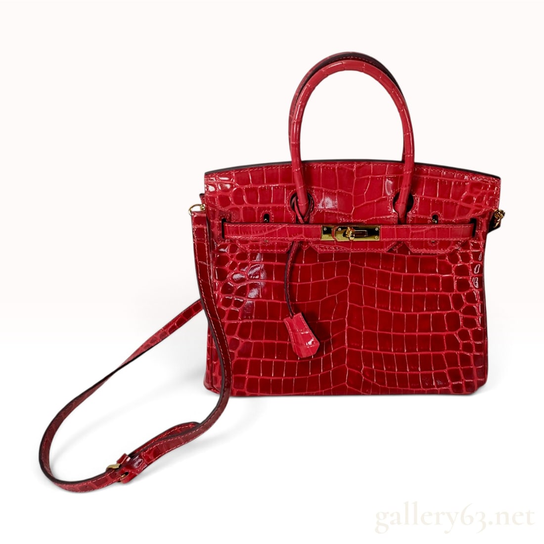 Genuine Crocodile Leather Birkin Style Satchel with Gold-Tone Hardware: A top-handle satchel bag crafted from genuine red crocodile leather with a high-gloss finish. The design features a classic silhouette with a flap top and dual rolled leather handles. The exterior lea