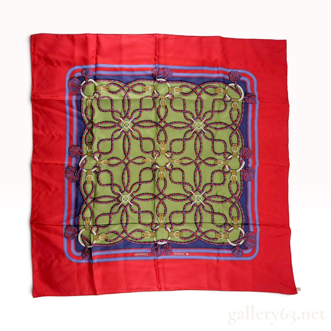 Hermes Cordelieres Silk Carre Scarf: An authentic silk scarf by the French luxury brand Hermes featuring the Cordelieres pattern. The design consists of a central olive green field decorated with a geometric arrangement of interlocking r