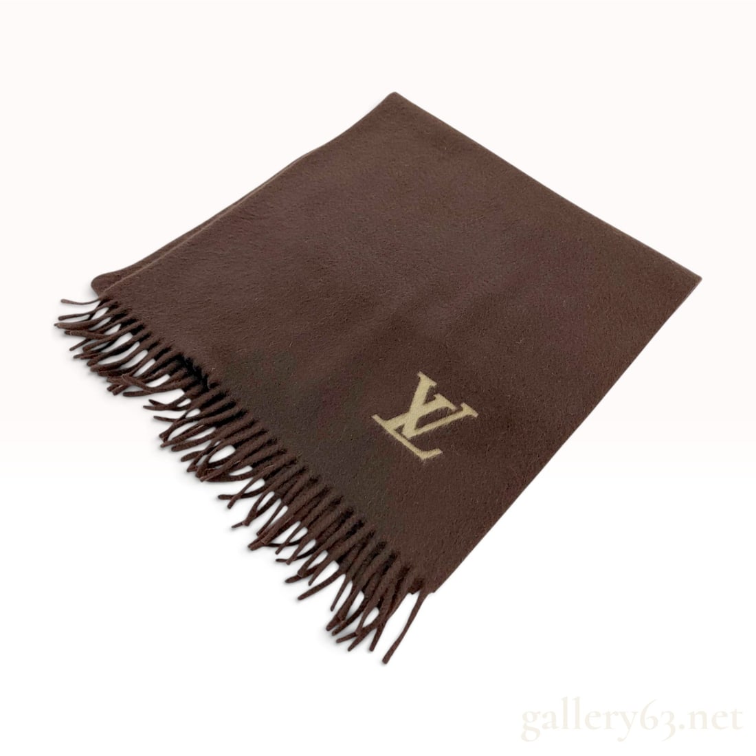 Louis Vuitton Brown 100% Cashmere Scarf: A Louis Vuitton scarf composed of 100 percent cashmere in a solid brown color. The design features a single LV monogram embroidered in a light tan thread at one corner and is finished with fringe ends