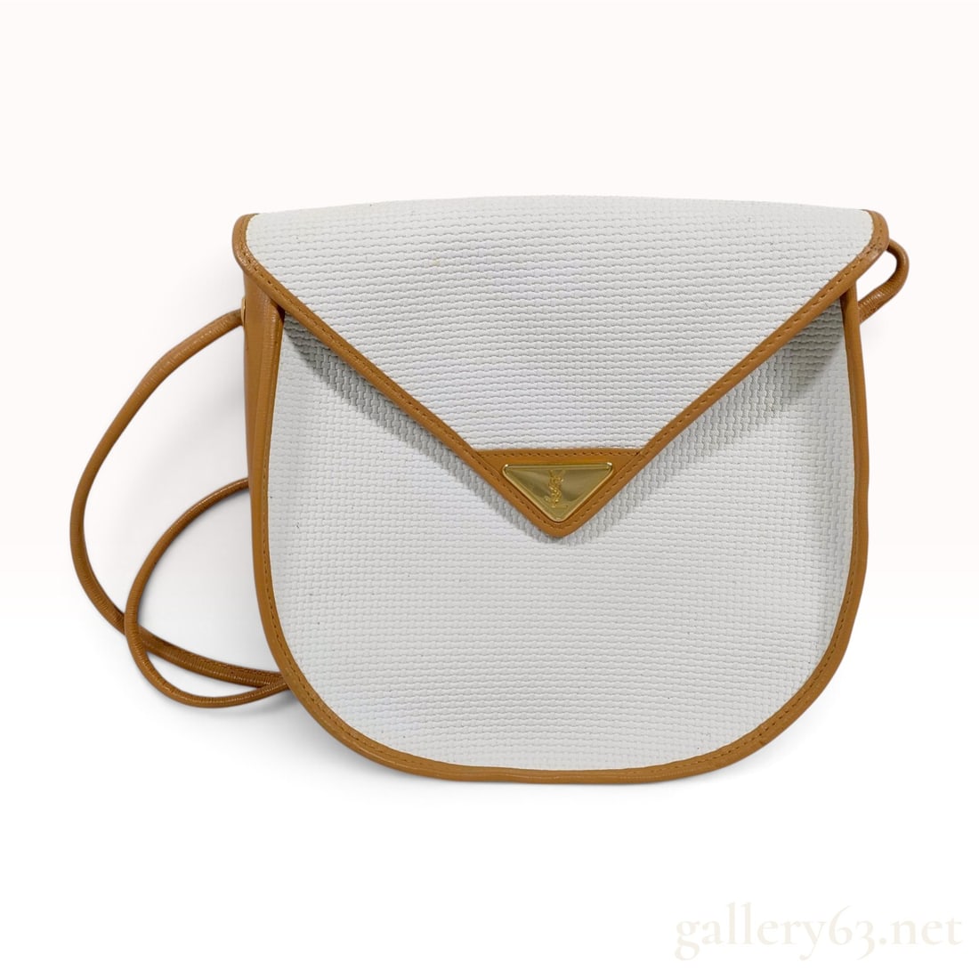 Yves Saint Laurent Rive Gauche Vintage Textured Canvas and Leather Crossbody Bag: This vintage Yves Saint Laurent crossbody bag from the Rive Gauche line features an envelope-style flap with a curved, semi-circular base. The exterior is constructed from cream-colored textured coate