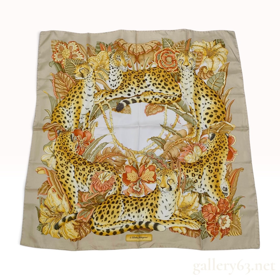 Vintage Salvatore Ferragamo Animalier Cheetah and Tropical Floral Beige Silk Scarf 90 cm: This item is in excellent pre-owned condition. A Salvatore Ferragamo silk scarf crafted from silk twill with hand-rolled and hand-stitched edges. The design features a central circular ivory field sur