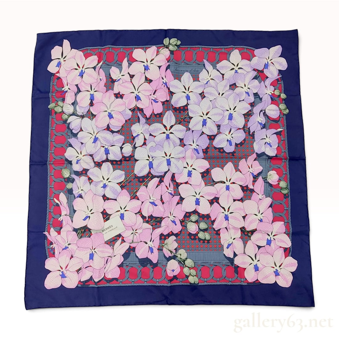 Hermes Souvenirs d'Asie 90cm Silk Twill Scarf: An authentic Hermes 90cm silk twill scarf featuring the Souvenirs d'Asie pattern designed by Caty Latham. The design depicts a dense arrangement of white, pink, and purple orchids on a navy blue groun