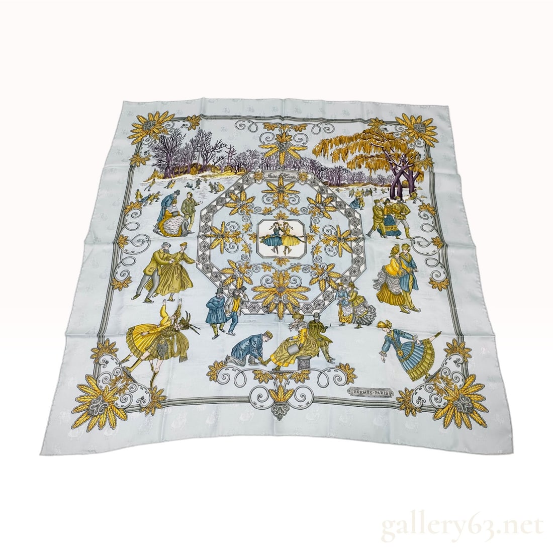 Hermes Joies d'Hiver Silk Jacquard Scarf: A 100% silk jacquard scarf by Hermes titled Joies d'Hiver (Joys of Winter). The central motif depicts 19th-century ice skating scenes in a park setting, framed by elaborate acanthus leaf scrolls and v