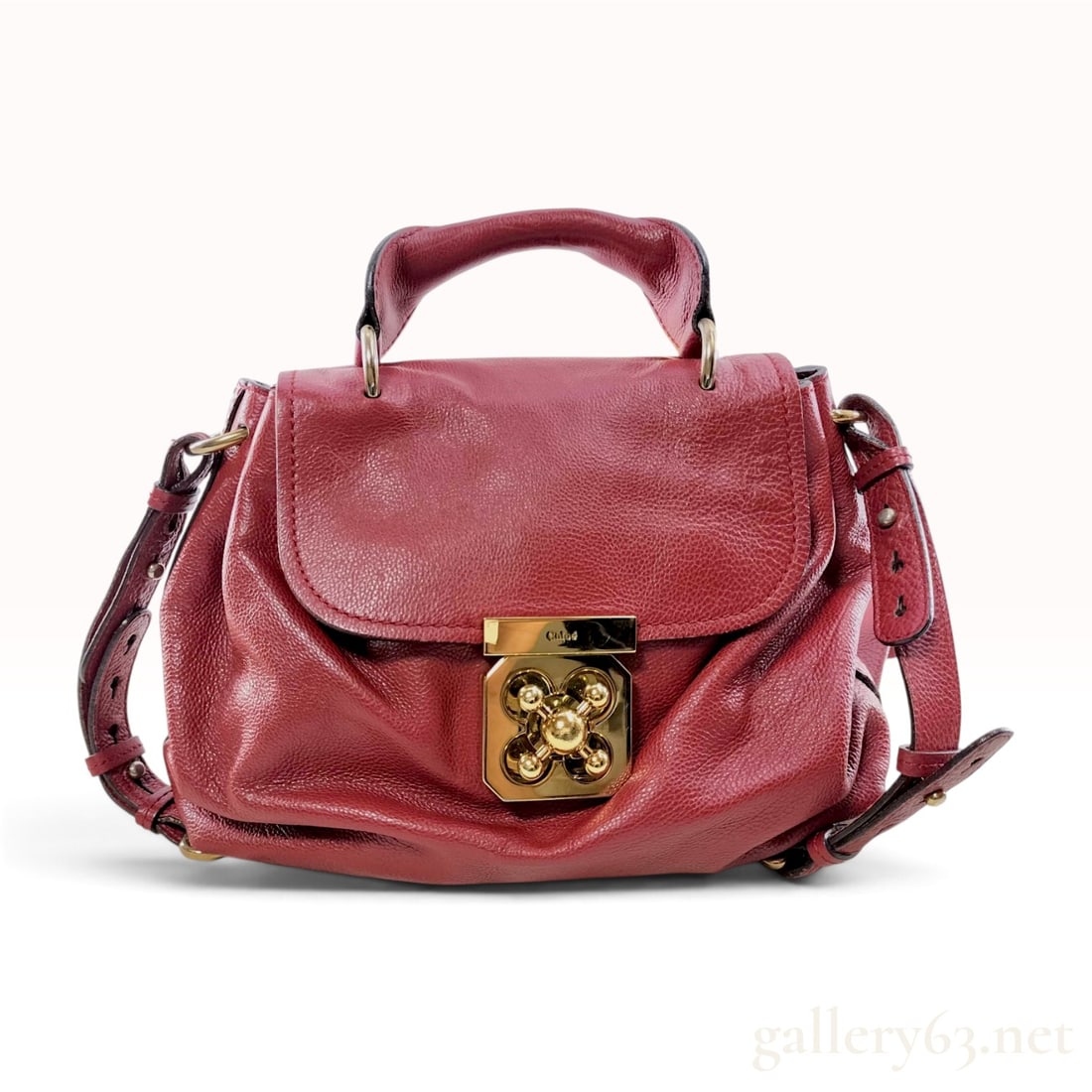 Chloe Elsie Red Pebbled Leather Handbag: Chloe Elsie satchel handbag crafted from deep red pebbled leather with gold-tone hardware. The bag features a front flap secured with a heavy gold-tone four-petal floral turn-lock clasp. The metal loc