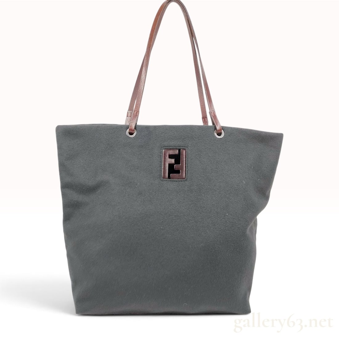 Fendi Charcoal Grey Felt and Mahogany Leather Zucca Logo Tote Bag: A Fendi shopper tote bag crafted from charcoal grey felted wool with mahogany brown leather accents. The bag features a structured leather base and dual flat leather shoulder straps. The straps are se