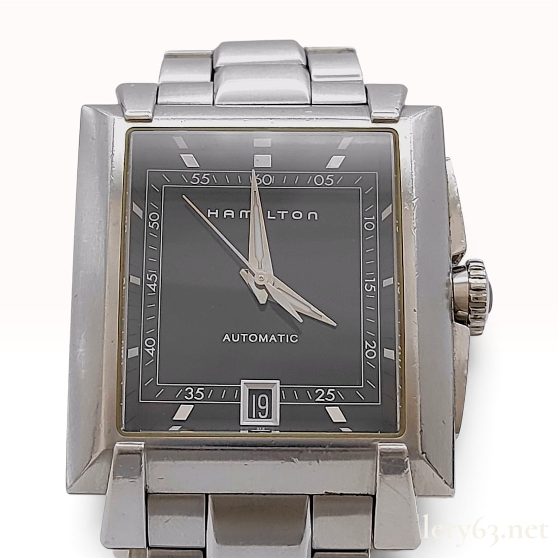 Hamilton Trent Automatic Stainless Steel Wristwatch with Box: The wristwatch is in pre-owned condition. This Hamilton Trent automatic wristwatch features a rectangular stainless steel case and a black dial with silvered baton indices and hands. The dial includes