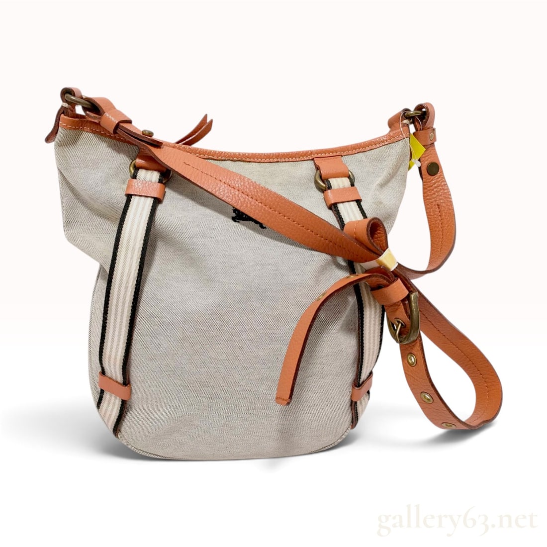 Burberry Blue Label Canvas and Leather Crossbody Shoulder Bag: A Burberry Blue Label crossbody shoulder bag featuring a beige canvas body and tan pebbled leather trim. The exterior is detailed with two vertical woven textile straps in a beige and white stripe pat