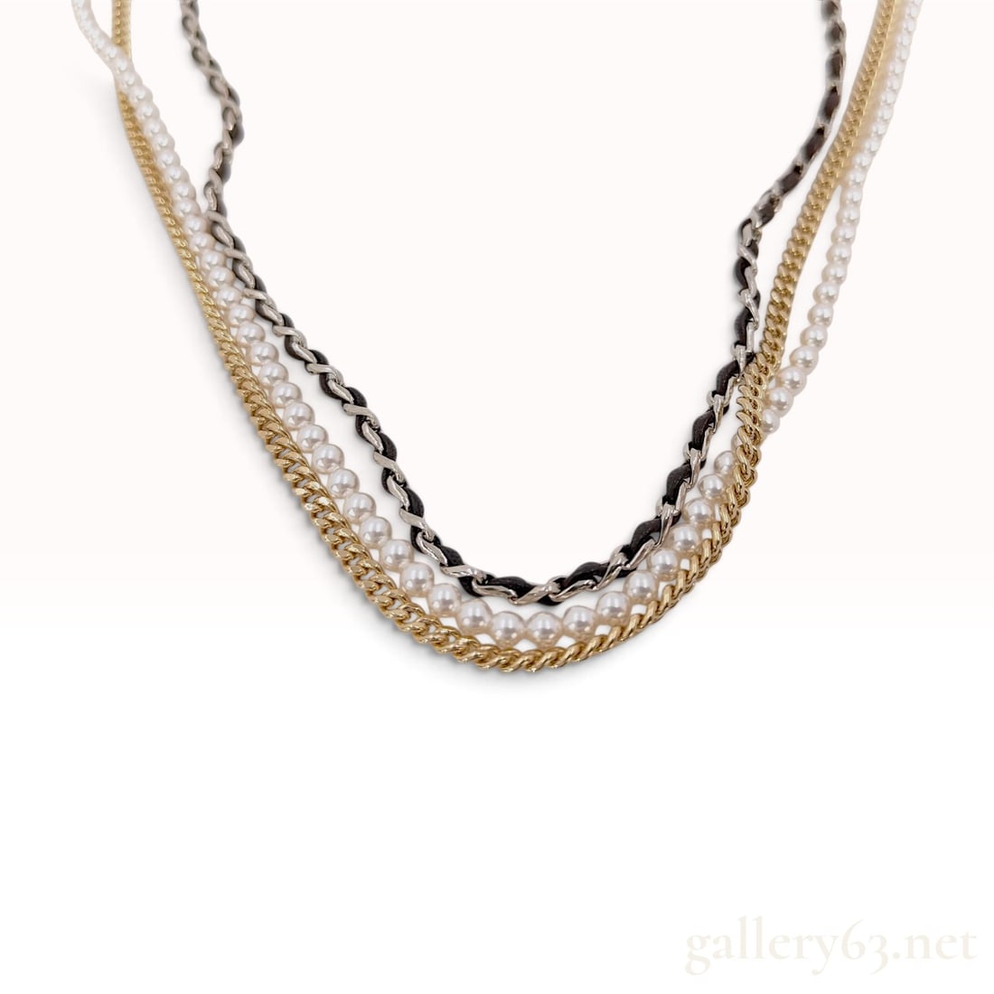 Chanel 2011 Triple Strand CC Logo Necklace with Faux Pearls and Mixed Metal Chains: A Chanel triple-strand necklace from the 2011 Continuous Collection. The piece features three distinct layered strands consisting of a row of graduated white faux pearls, a gold-tone curb chain, and a