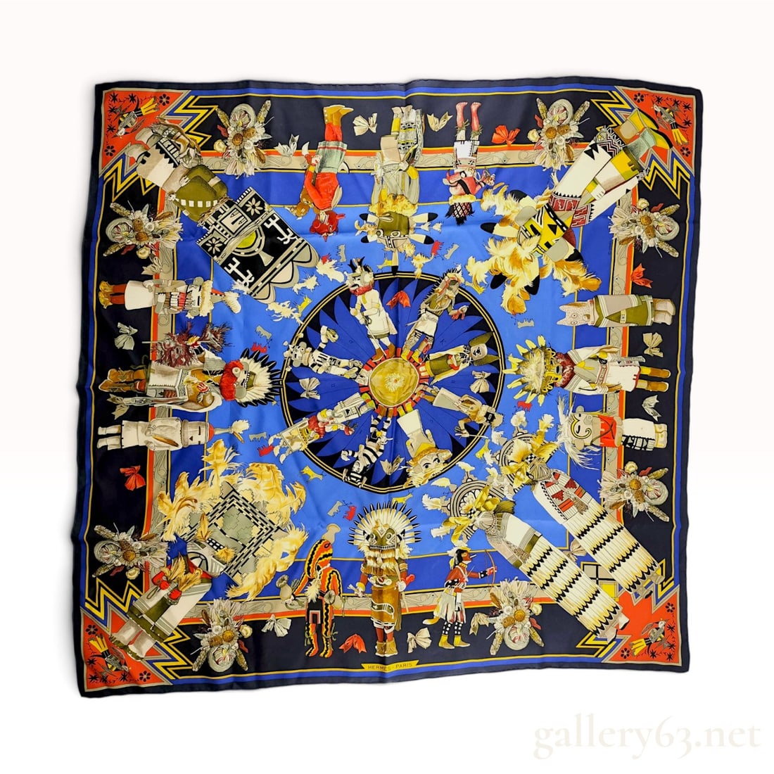 Hermes Kermit Oliver Kachinas Silk Scarf: An Hermes silk twill scarf featuring the Kachinas pattern designed by artist Kermit Oliver. The composition depicts stylized Hopi Native American spirit beings arranged in concentric circles and decor