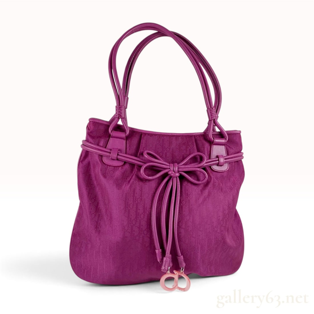 Christian Dior Fuchsia Diorissimo Canvas Romantique Bow Tote: This Christian Dior Romantique Bow Tote is crafted from fuchsia Diorissimo monogram jacquard canvas. The exterior features fuchsia leather trim, including rolled leather double handles and a decorativ