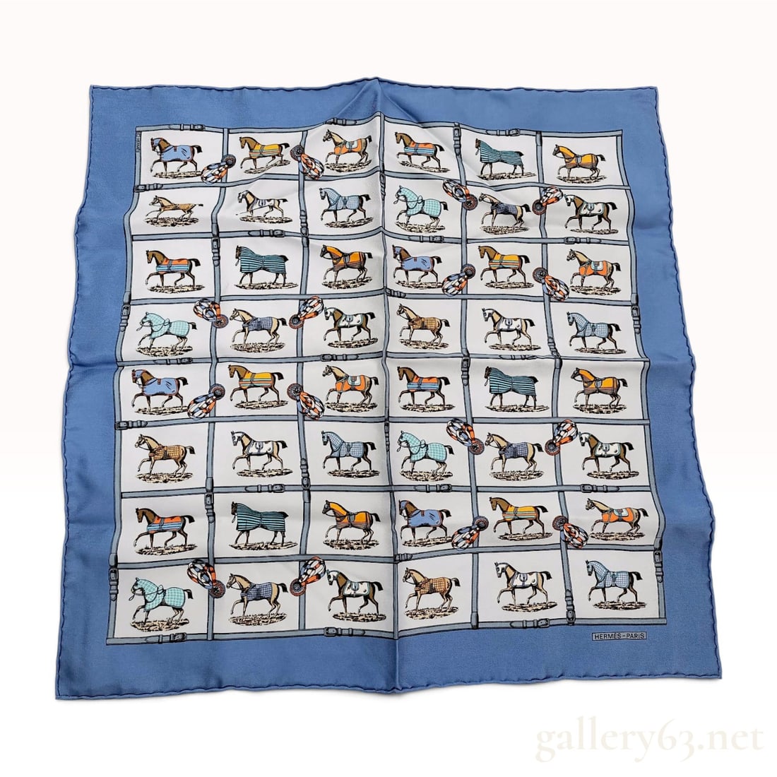 Hermes Couvertures et Tenues de Jour Silk Gavroche Pocket Square: This authentic Hermes silk Gavroche pocket square features the iconic Couvertures et Tenues de Jour (Horse Blankets and Day Outfits) pattern designed by Jacques Eudel. The composition displays a varie