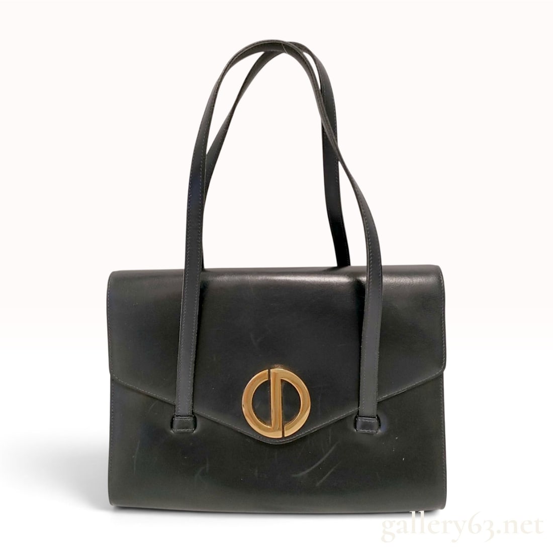Christian Dior Vintage Black Leather CD Clasp Shoulder Bag: A vintage Christian Dior shoulder bag constructed from smooth black leather. The rectangular, structured body features dual flat shoulder straps attached to the exterior panels with rectangular leathe