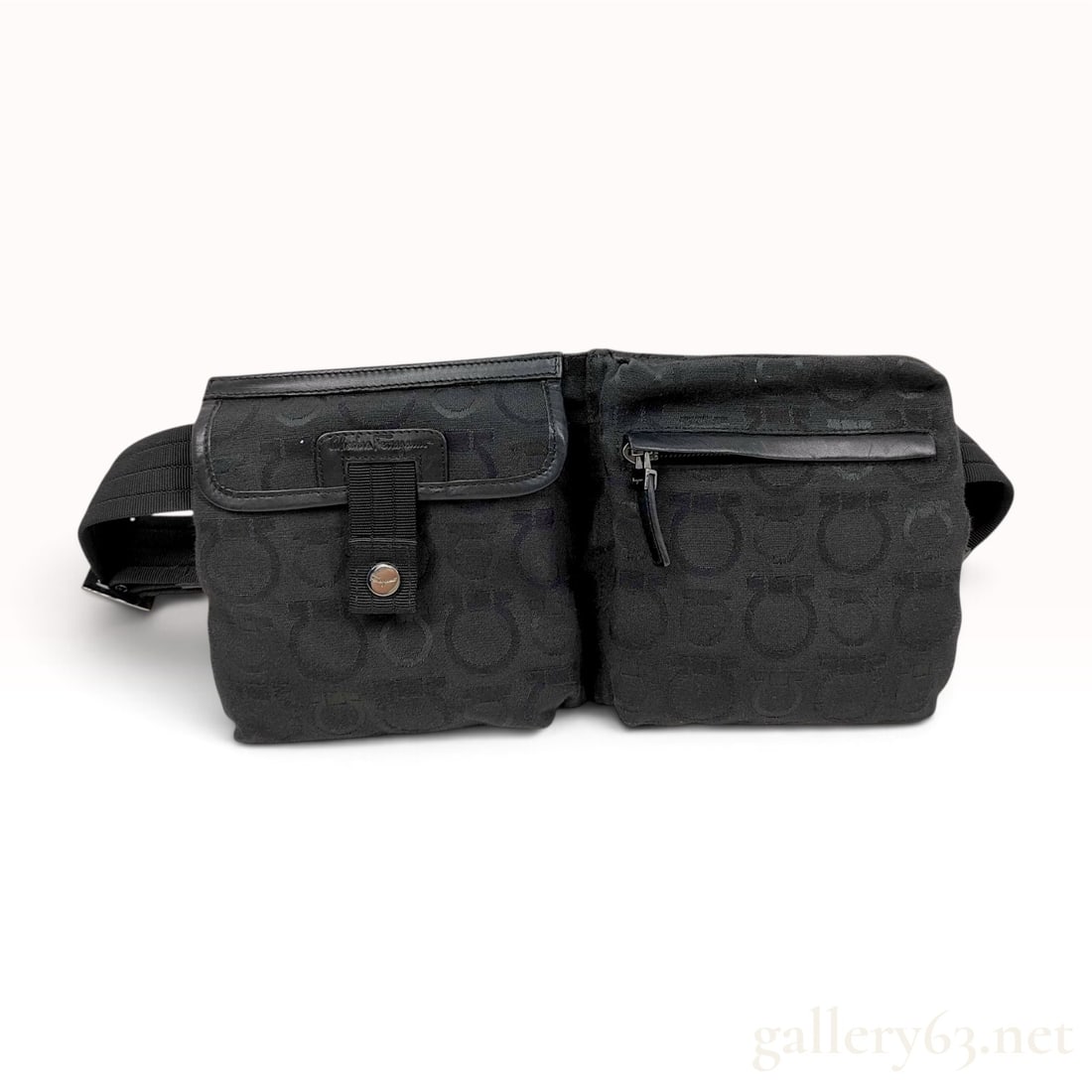 Salvatore Ferragamo Gancini Monogram Canvas Belt Bag: This Salvatore Ferragamo belt bag is constructed from black jacquard-woven canvas featuring an all-over Gancini monogram pattern. The functional design includes two front compartments: a left pocket w