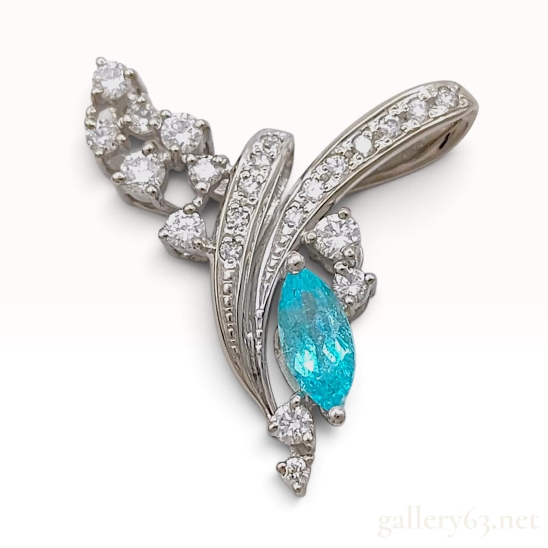 18KWG GIA Brazilian .40ct Paraiba Tourmaline and 0.46ctw Natural Diamond Pendant: This contemporary 18 karat white gold pendant features a fluid, abstract design with sweeping, wing-like elements. The centerpiece is a marquise-cut natural Paraiba tourmaline exhibiting a vibrant neo