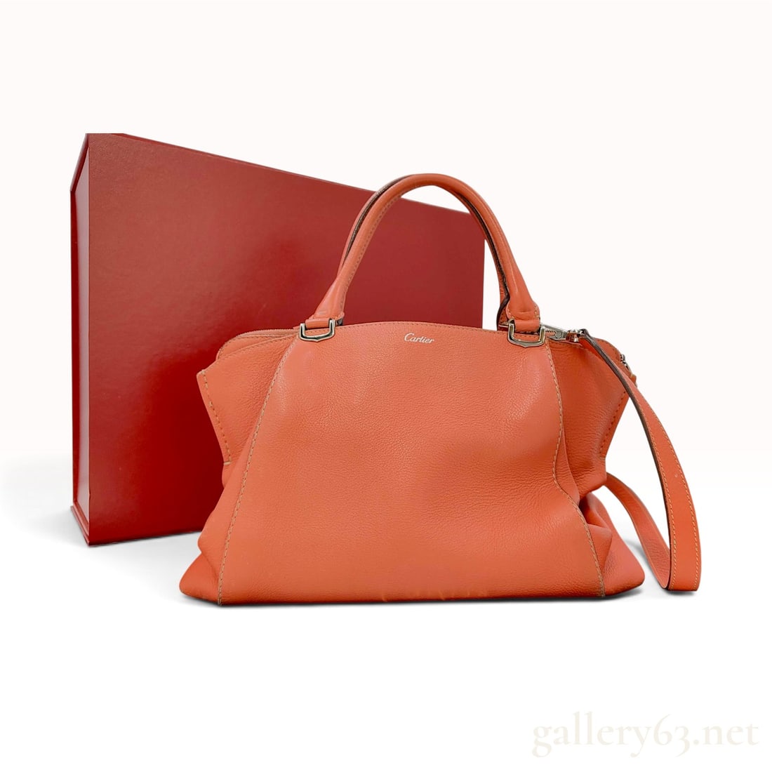 Cartier C de Cartier Orange Grained Leather Top Handle Bag with Box: This Cartier C de Cartier bag is crafted from coral orange grained leather with silver-tone hardware. The satchel design features signature C-shaped metal handle attachments, dual rolled top handles, 