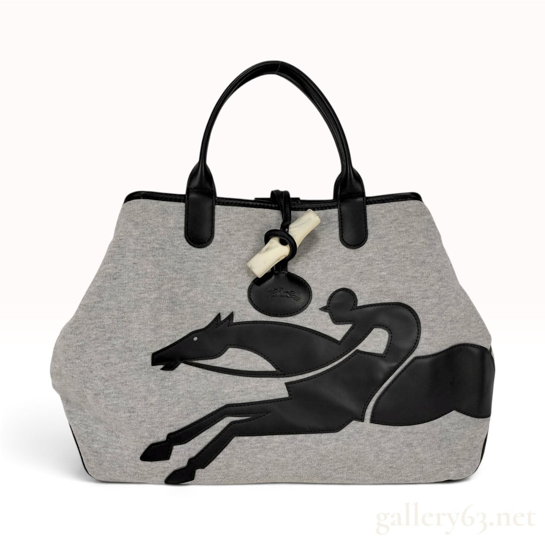 Longchamp Roseau Grey Jersey and Black Leather Tote Bag: This Longchamp Roseau tote bag is constructed with a grey marl jersey knit body and black leather trim, featuring a reinforced black leather base and double top handles. The front is decorated with an