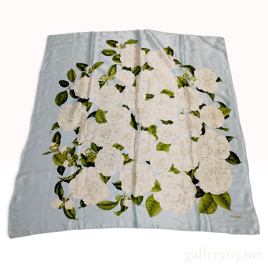 Vintage 90cm Silk Chanel Camellia Floral Pale Blue Scarf: This Chanel silk scarf 90 cm is crafted from fine silk and features the iconic camellia floral motif, a signature of the house. The design displays a dense, central bouquet of white camellias in vario