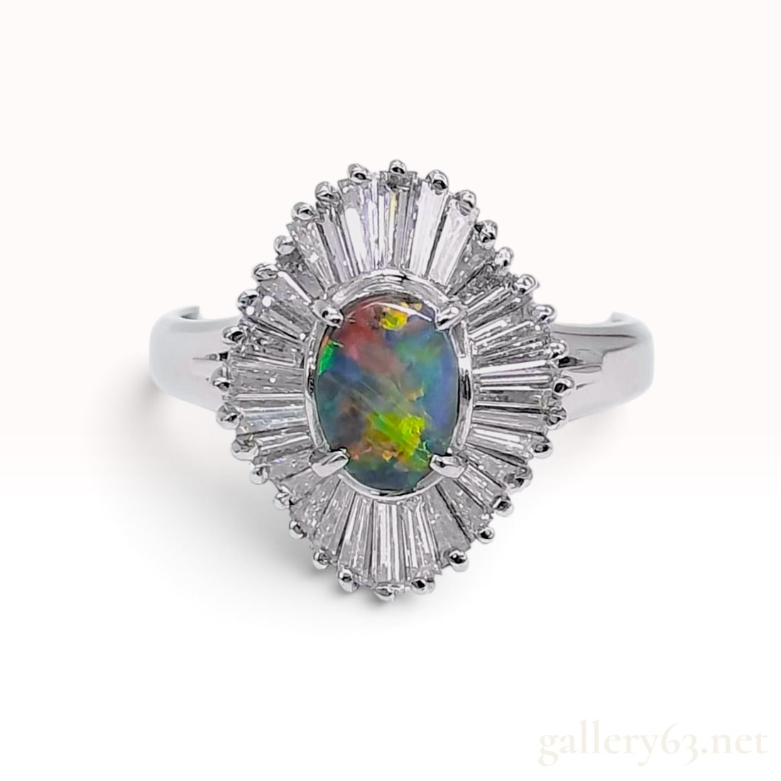 Pt900 Platinum 0.62ct Natural Black Opal and 0.87ctw Natural Diamond Ballerina Ring: This ballerina ring crafted from Pt900 platinum features a central oval cabochon natural black opal. The opal weighs 0.62ct and displays a multi-color play-of-color with flashes of red, orange, green,