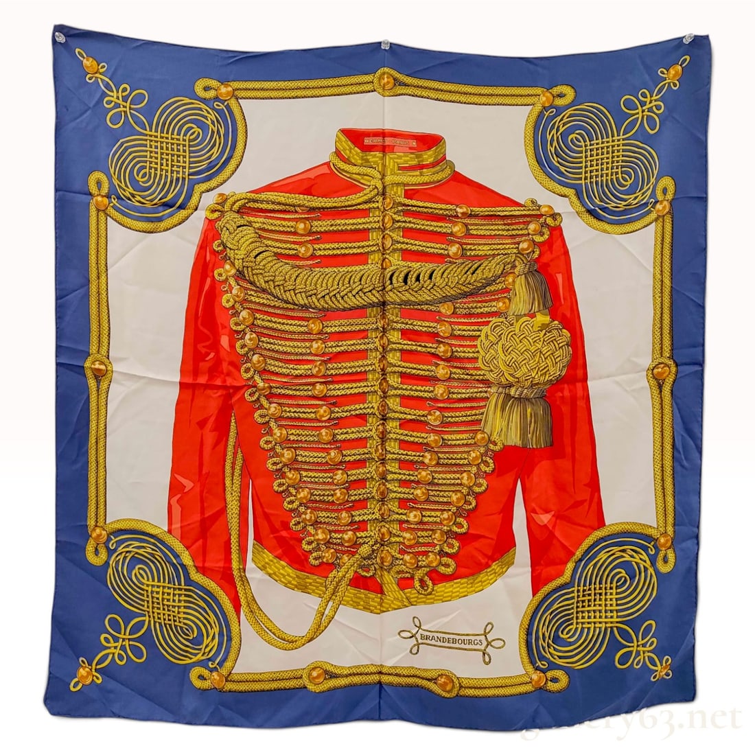 Vintage Hermes Brandebourgs Silk Carre 90: This is a Hermes silk carre 90 in the Brandebourgs pattern designed by Cathy Latham. The design features a central red 19th-century hussar-style military jacket heavily decorated with ornate gold brai