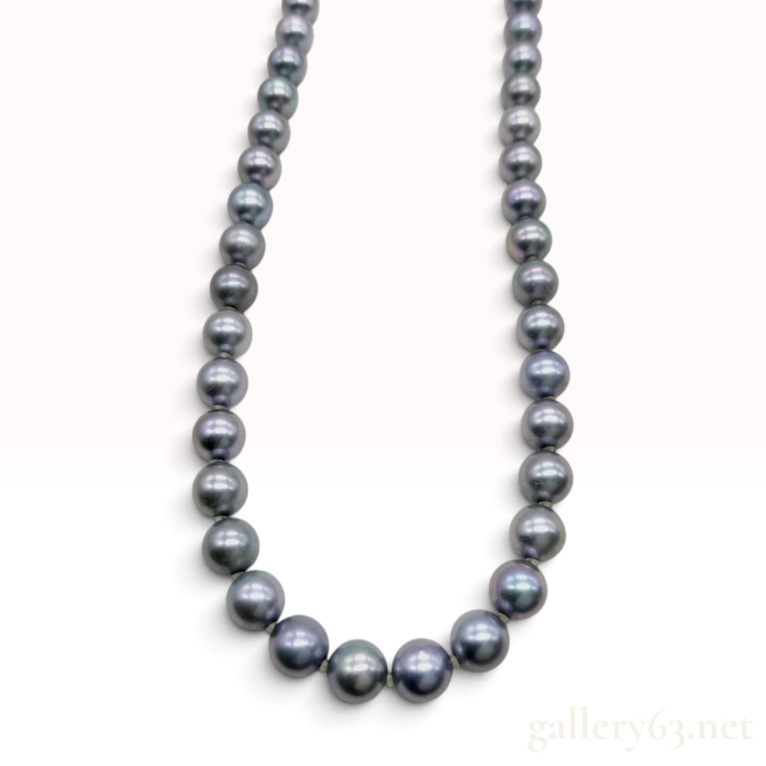 Silver and Graduated Silvery-Grey Cultured Pearl Necklace 18 Inch: This necklace is crafted from a single strand of graduated cultured pearls exhibiting a silvery-grey body color with subtle pinkish and greenish overtones. The pearls are hand-knotted on grey thread w