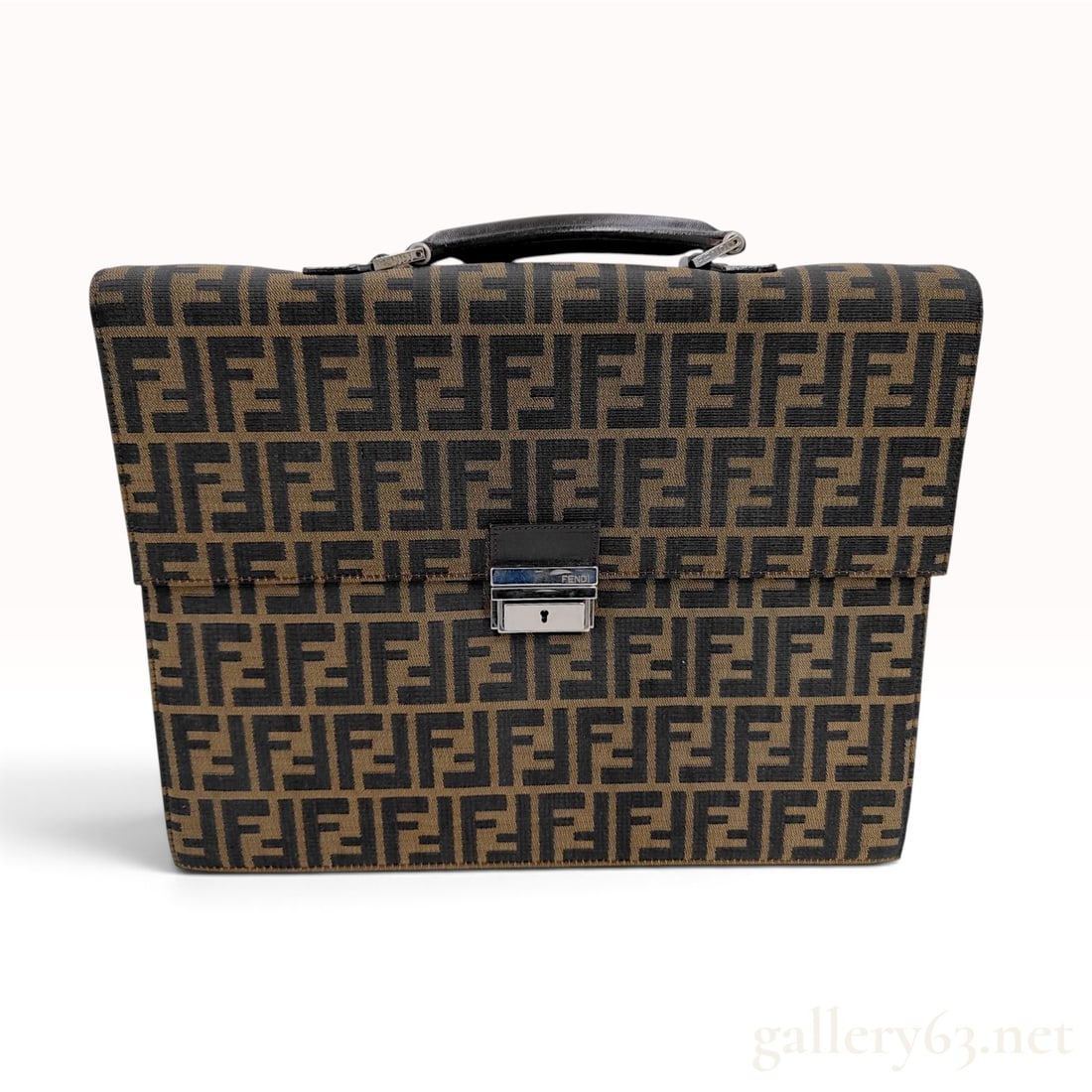 Vintage Fendi Zucca Monogram Tobacco Canvas Briefcase: This vintage Fendi briefcase is crafted from tobacco-toned Zucca monogram jacquard canvas with dark brown leather trim. The structured design features a single leather top handle and a fold-over flap 