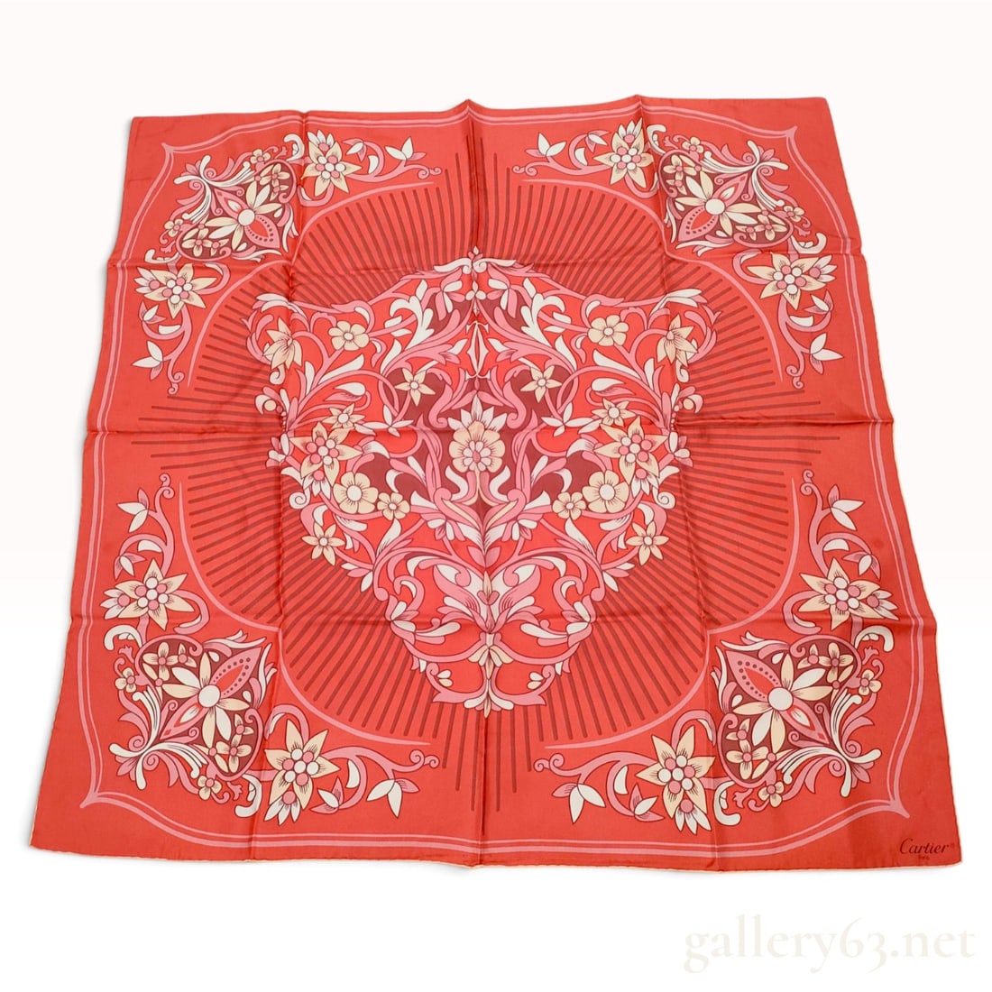 Vintage Cartier Red Floral Silk Carre 90: This Cartier silk carre 90 is crafted from 100% silk twill with hand-rolled hems. The composition features a symmetrical kaleidoscopic floral and foliate design in a palette of pink, cream, and deep b