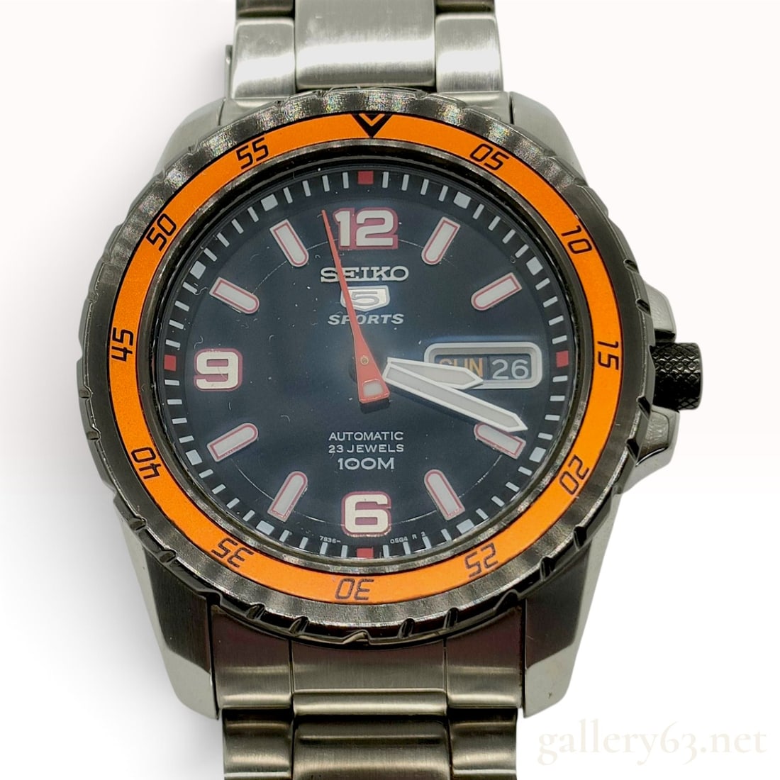 42mm Seiko 5 Sports Automatic Stainless Steel Navy and Orange Wristwatch: Working condition. A Seiko 5 Sports wristwatch featuring a 41.1 mm stainless steel case with a dark grey unidirectional rotating bezel and an orange 60-minute insert. The dark navy blue dial displays 