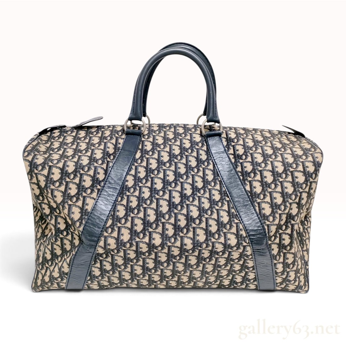 Vintage Christian Dior Trotter Navy and Beige Canvas Boston Bag: This Christian Dior Trotter Boston bag is crafted from navy blue and beige monogram canvas with navy blue leather trim and dual rolled leather top handles. The exterior features the signature Oblique 