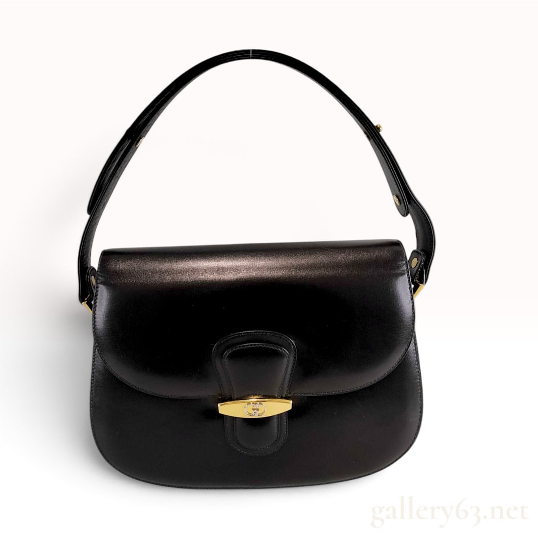 Vintage Gucci Black Box Calf Leather Shoulder Bag: This Gucci shoulder bag is constructed from smooth black box calf leather with a structured, accordion-style silhouette. The design features a flap-top closure secured by a gold-toned metal turn-lock 