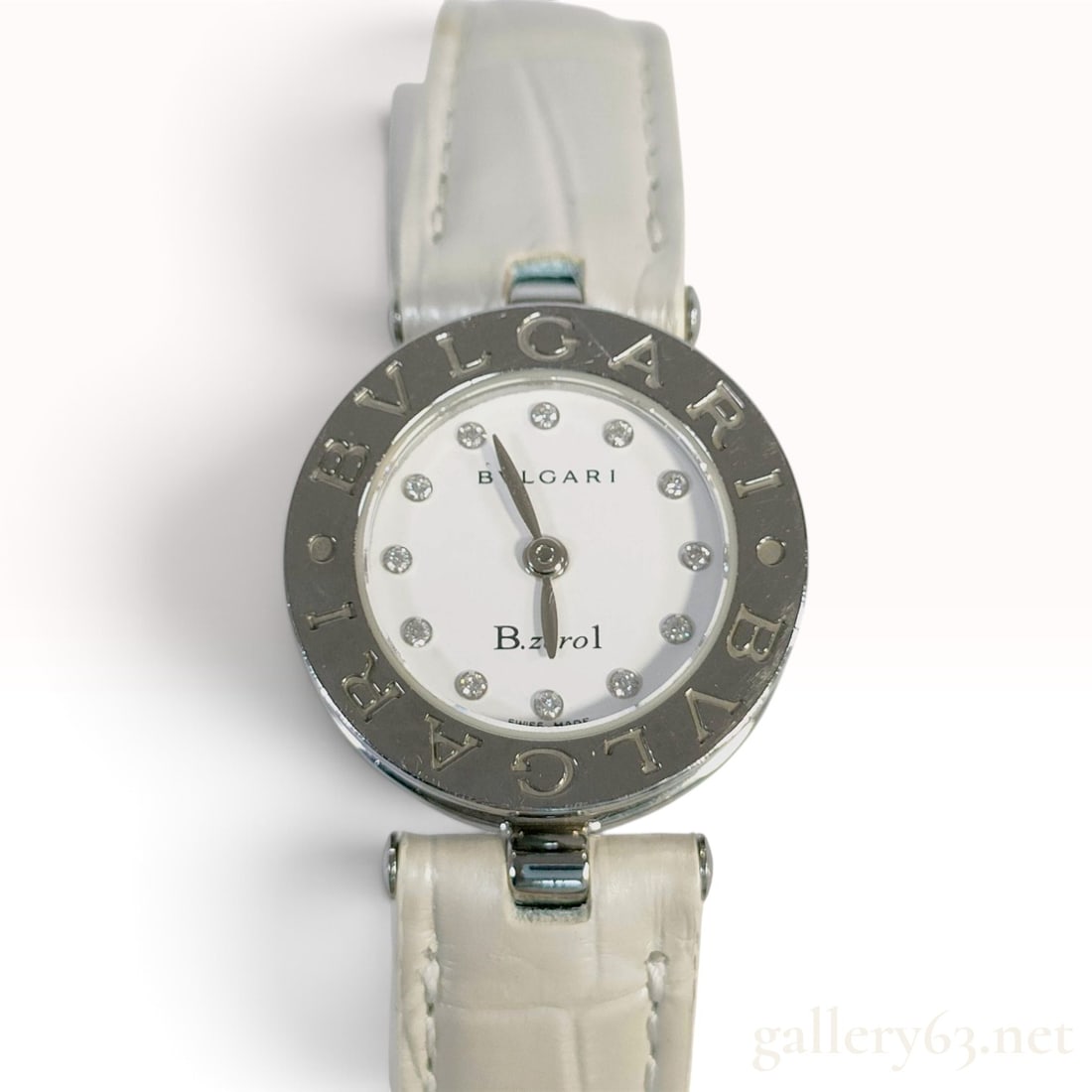 Bulgari B.zero1 BZ 22 S White Diamond Dial Stainless Steel Wristwatch: This Bulgari B.zero1 wristwatch is crafted with a signature cylindrical stainless steel case and a bezel engraved twice with the brand logo. The white dial is set with twelve round-cut natural diamond