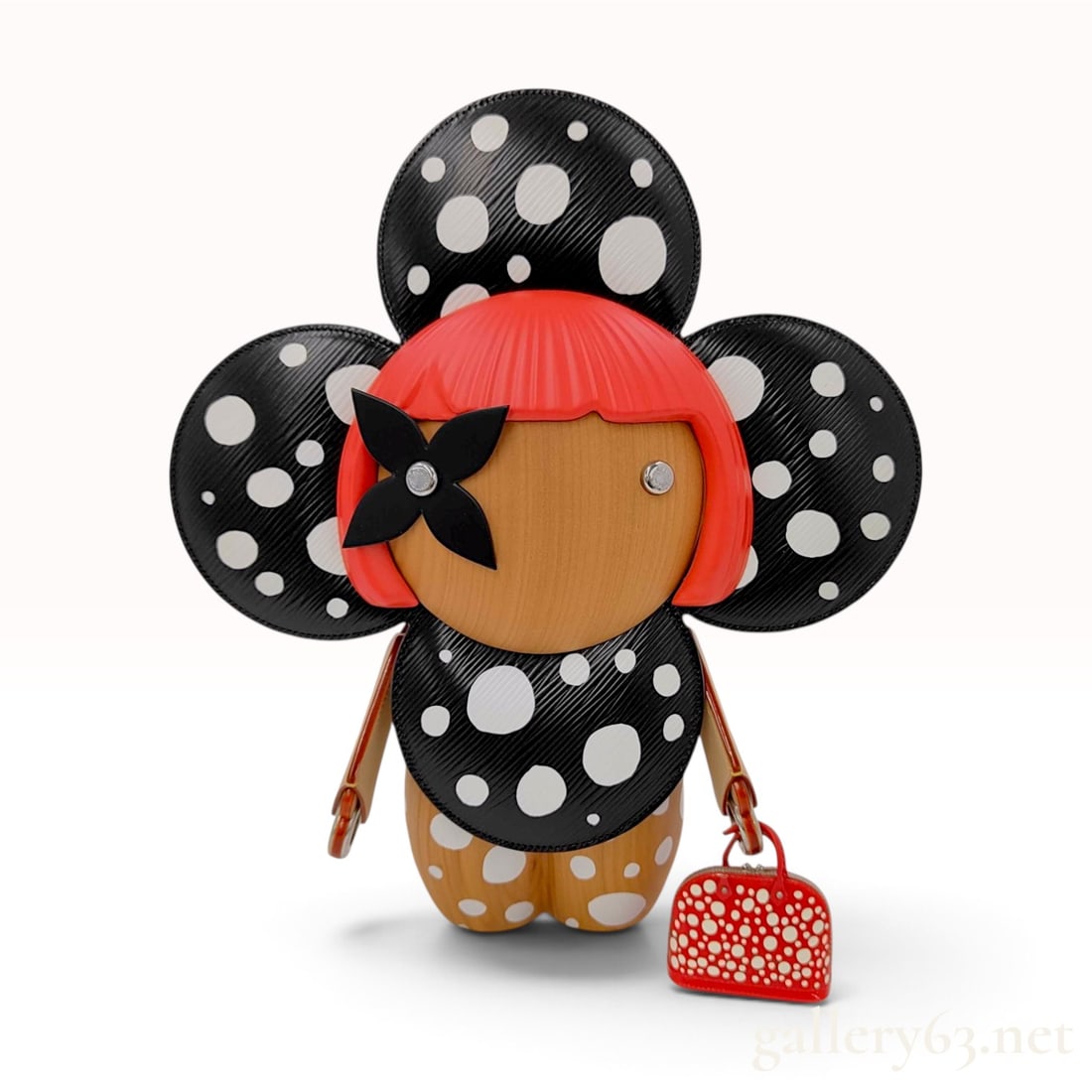 Louis Vuitton x Yayoi Kusama Infinity Dots Vivienne Giant Wood and Epi Leather Figurine: This Louis Vuitton x Yayoi Kusama Infinity Dots Vivienne Giant figurine is crafted from polished wood and black Epi leather. The figure features a light brown wood body and head decorated with