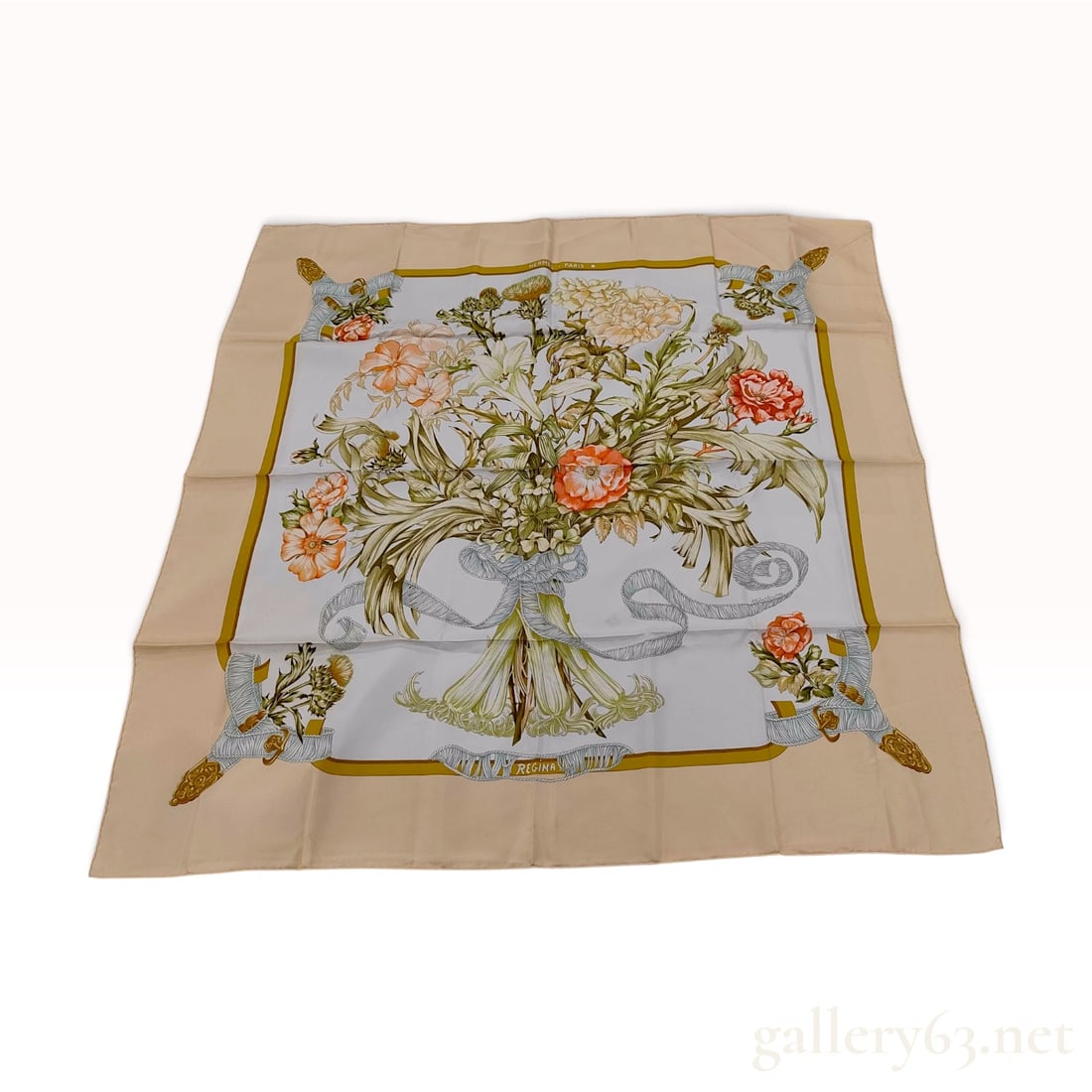 Vintage Hermes Regina Silk Carre 107 in Beige and Cream: This vintage Hermes silk carre 107 is designed in the Regina pattern by artist Leila Menchari. The composition features a lush central bouquet of lilies, roses, and carnations secured with a light blu