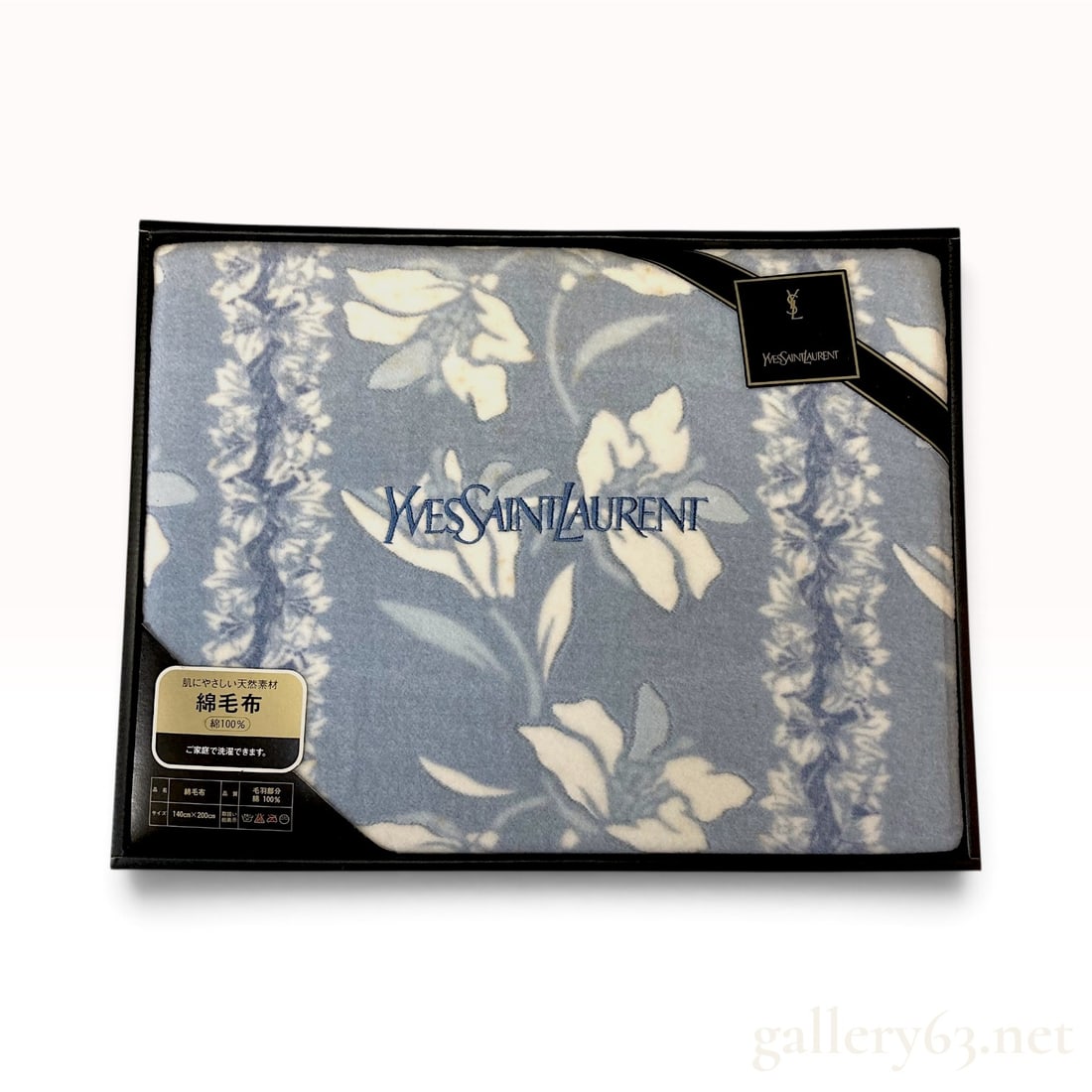 Yves Saint Laurent Floral Vine Light Blue Cotton Blanket 140 x 200 cm with Box: This Yves Saint Laurent cotton blanket is crafted from a 100% cotton pile featuring a white floral and vine pattern against a light blue ground. The center of the textile is embroidered with the name