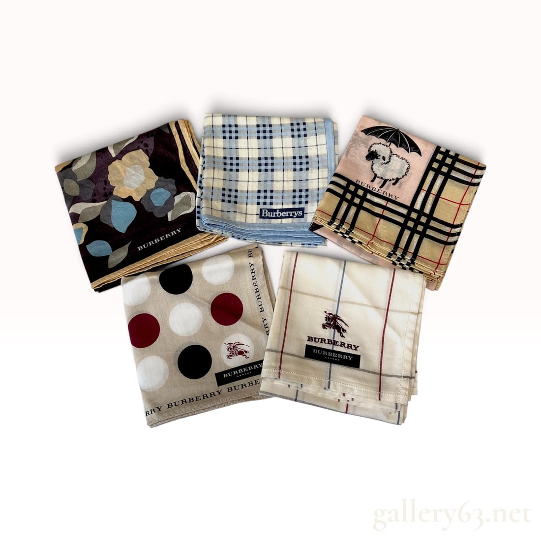 Five Burberry Assorted Pattern Cotton Scarves 50cm: This set of five Burberry scarves is crafted from lightweight cotton. The collection features a variety of signature and whimsical patterns. The first is a dark floral design with large-scale motifs i