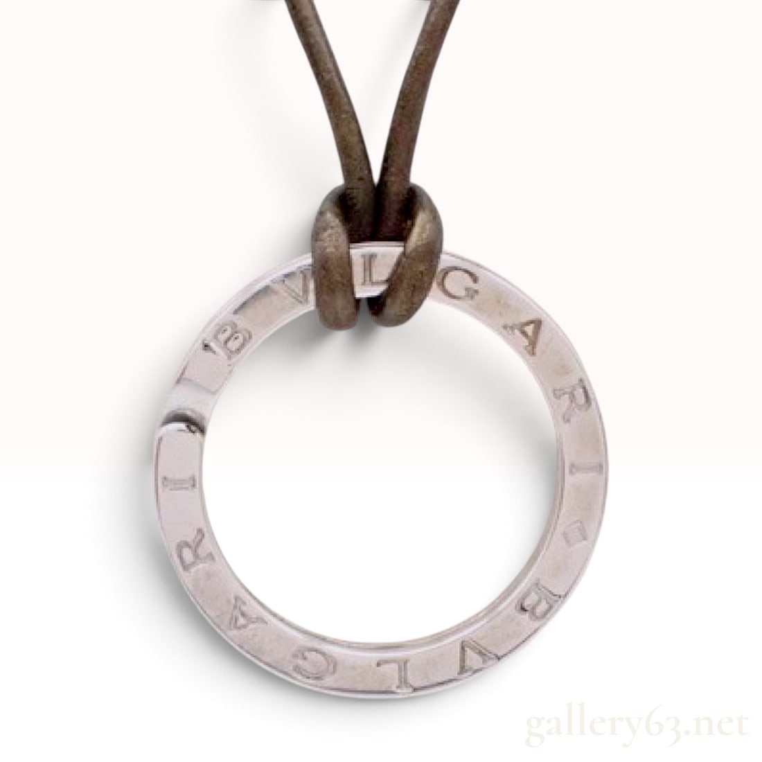 Bvlgari Bvlgari Sterling Silver Pendant Cord Necklace: This Bvlgari Bvlgari pendant cord necklace is crafted from sterling silver and a dark brown cord. The pendant features a circular ring with a split-opening design, secured to the cord via a lark's hea