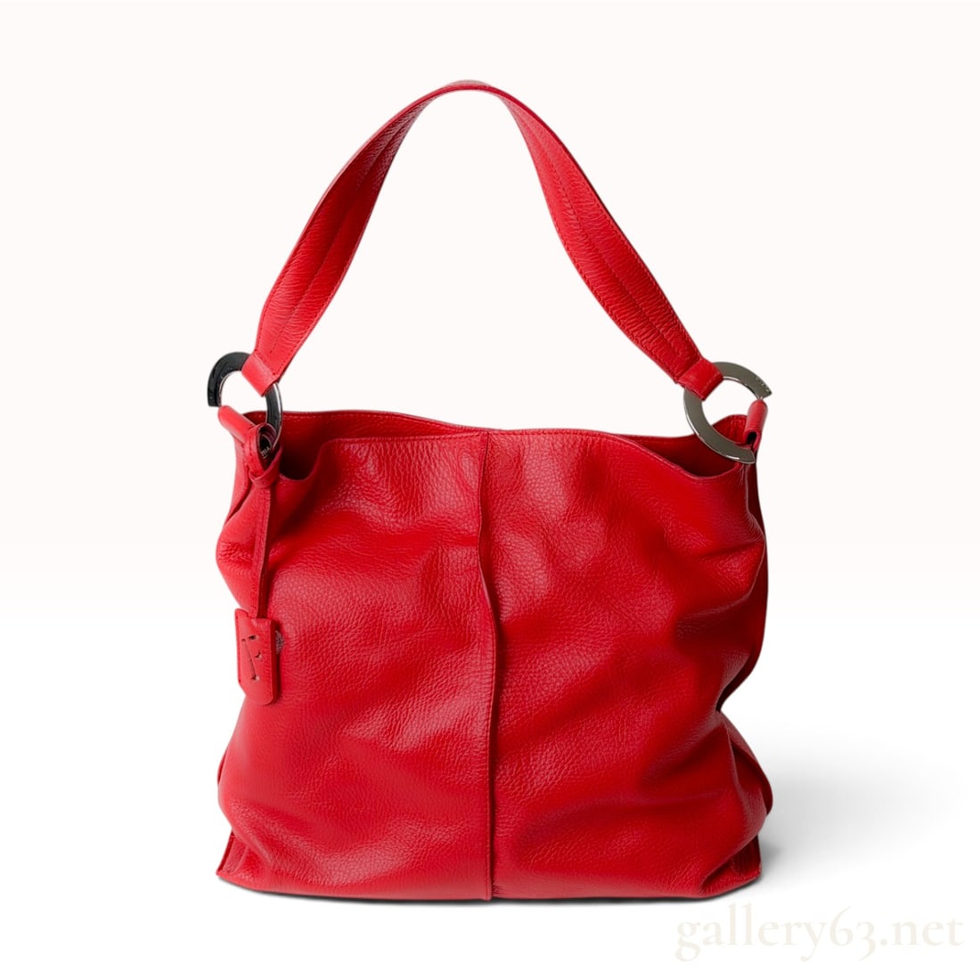 Furla Red Pebbled Leather Large Hobo Shoulder Bag: This Furla hobo shoulder bag is crafted from red pebbled leather featuring a central vertical seam on the front and back. The bag is designed with a single wide leather shoulder strap attached by poli