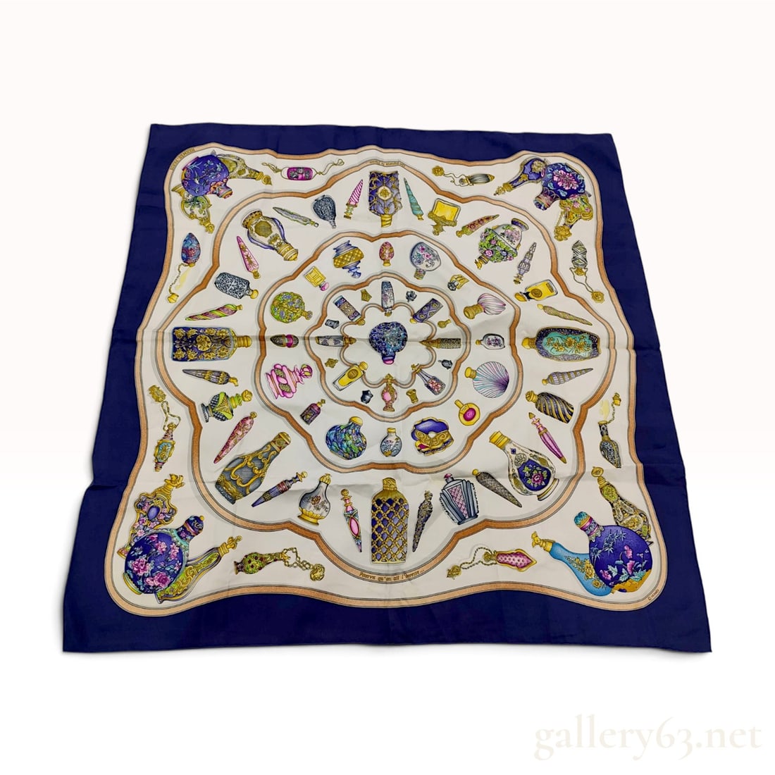 Hermes Pourvu qu'on ait l'ivresse Navy Blue Silk Carre 90: This Hermes silk carre 90 features the Pourvu qu'on ait l'ivresse pattern designed by Franck de la Perriere. The screen-printed design illustrates an array of ornate historical perfume bottles and fla