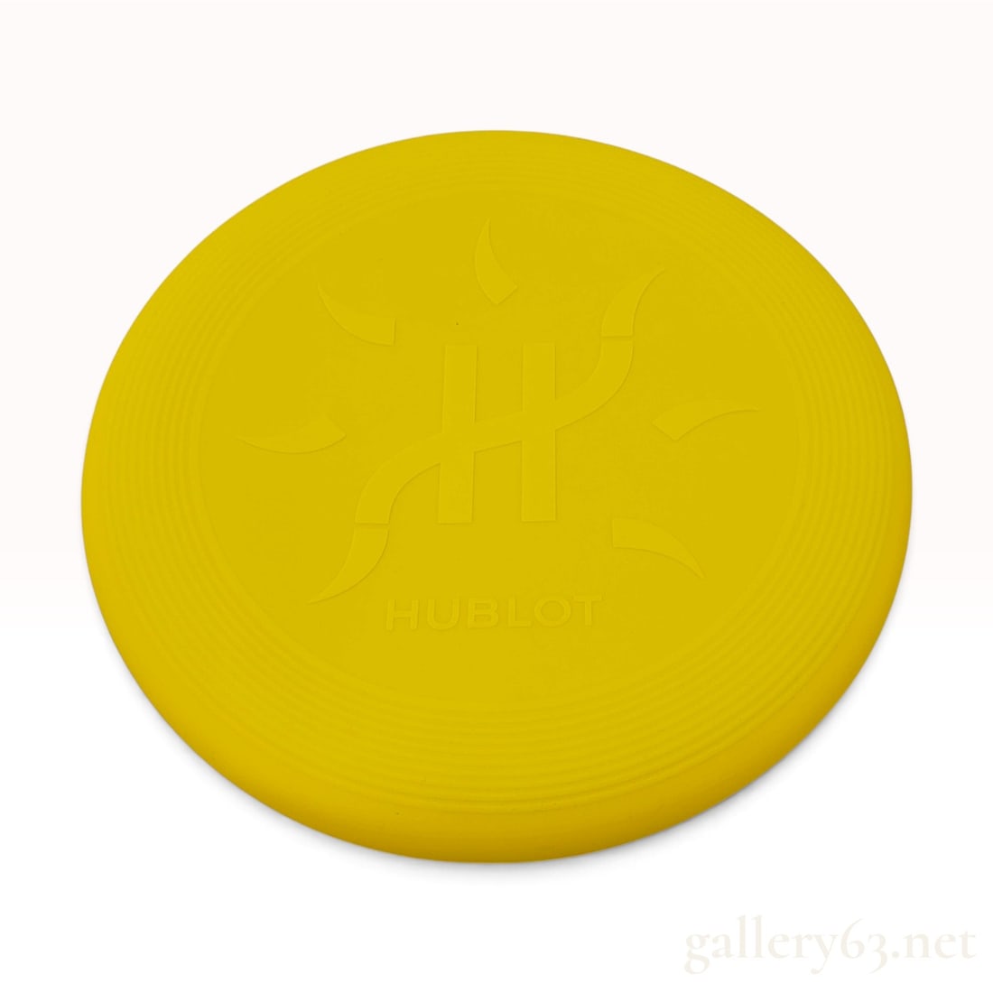 Hublot Yellow Plastic Flying Disc: This Hublot flying disc is crafted from flexible yellow polymer and features promotional branding for the luxury Swiss watchmaker. The top face of the disc is finished with an embossed central logo co