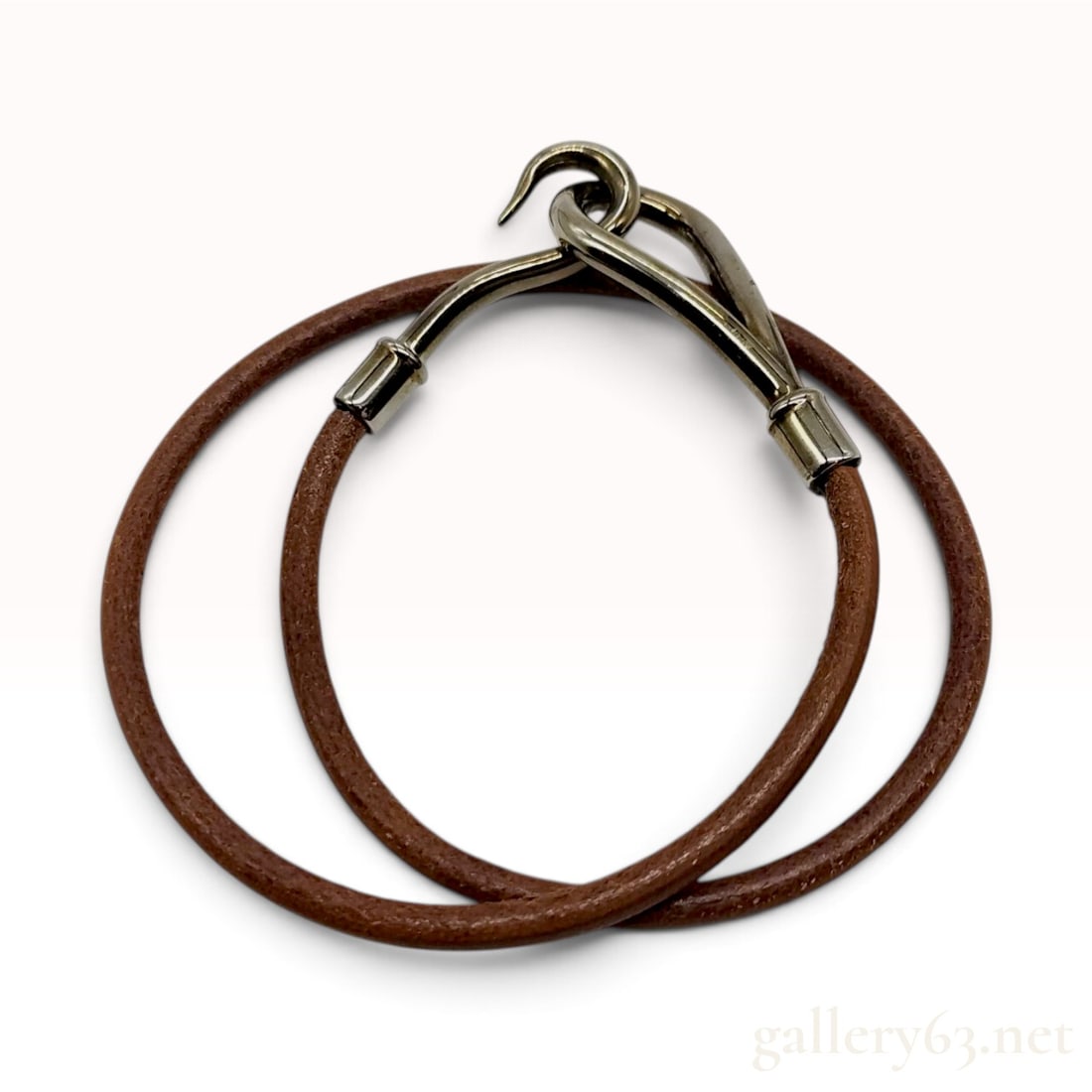 Hermes Jumbo Hook Brown Leather Double Wrap Bracelet with Box: This is a Hermes Jumbo bracelet featuring a double-wrap brown leather cord and metal hardware. The design utilizes a hook and loop interlocking closure. The leather cord is anchored into cylindrical m