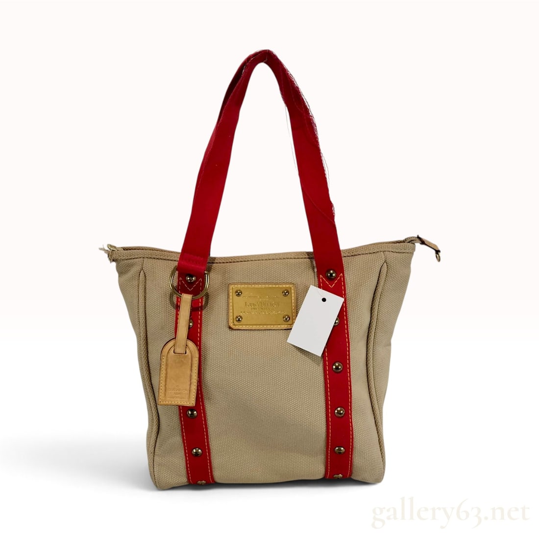 Vintage Louis Vuitton Antigua Cabas PM Beige Canvas Tote Bag: This Louis Vuitton Antigua Cabas PM tote bag is constructed from heavy-duty beige canvas with red canvas straps and structural trim. Part of the first all-canvas collection from the mid-2000s, it feat