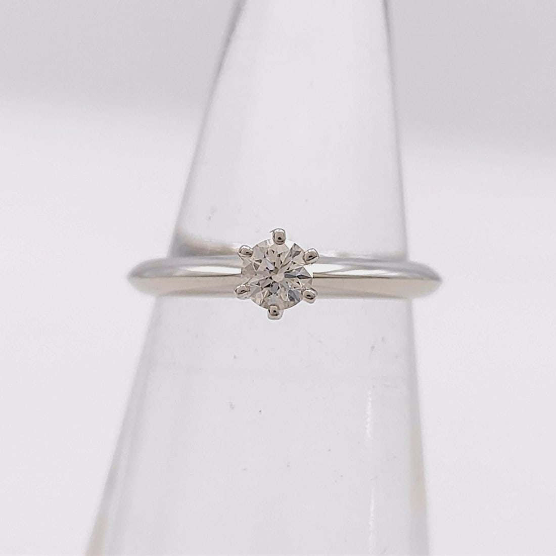 Tiffany and Co. I-VS1-3EX-NONE Platinum and 0.19ct Diamond Ring with Box and Certificate: This Tiffany and Co. solitaire engagement ring is crafted from platinum and features a center-set round brilliant cut 0.19ct natural diamond. The diamond is secured in a classic six-prong Tiffany sett